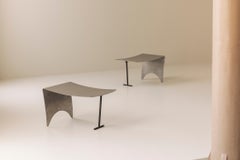A striking set Modernist curved metal stools from France, dating to the 1980s.