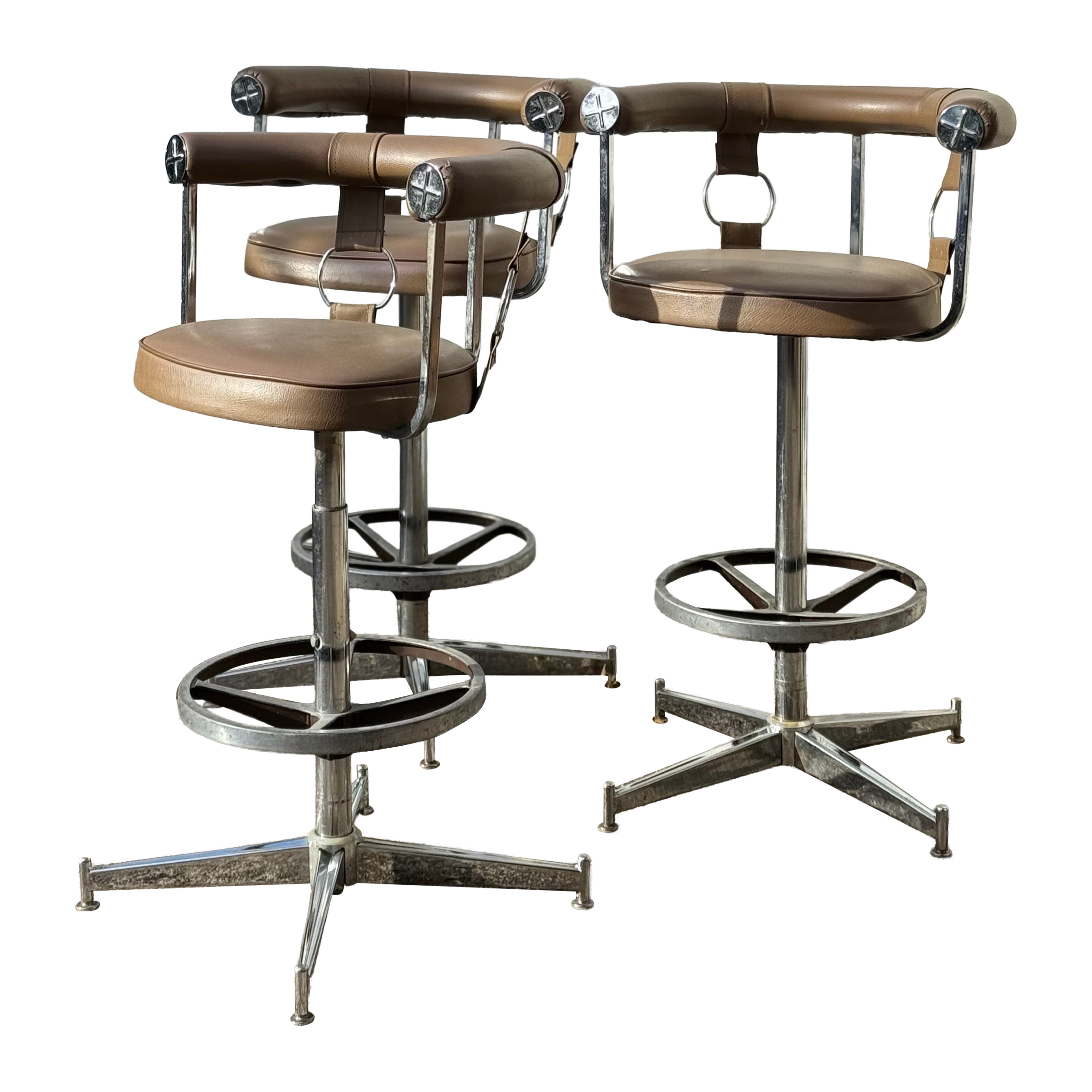 A striking set of 3 swivel bar stools by Daystrom furniture of Boston, featuring For Sale