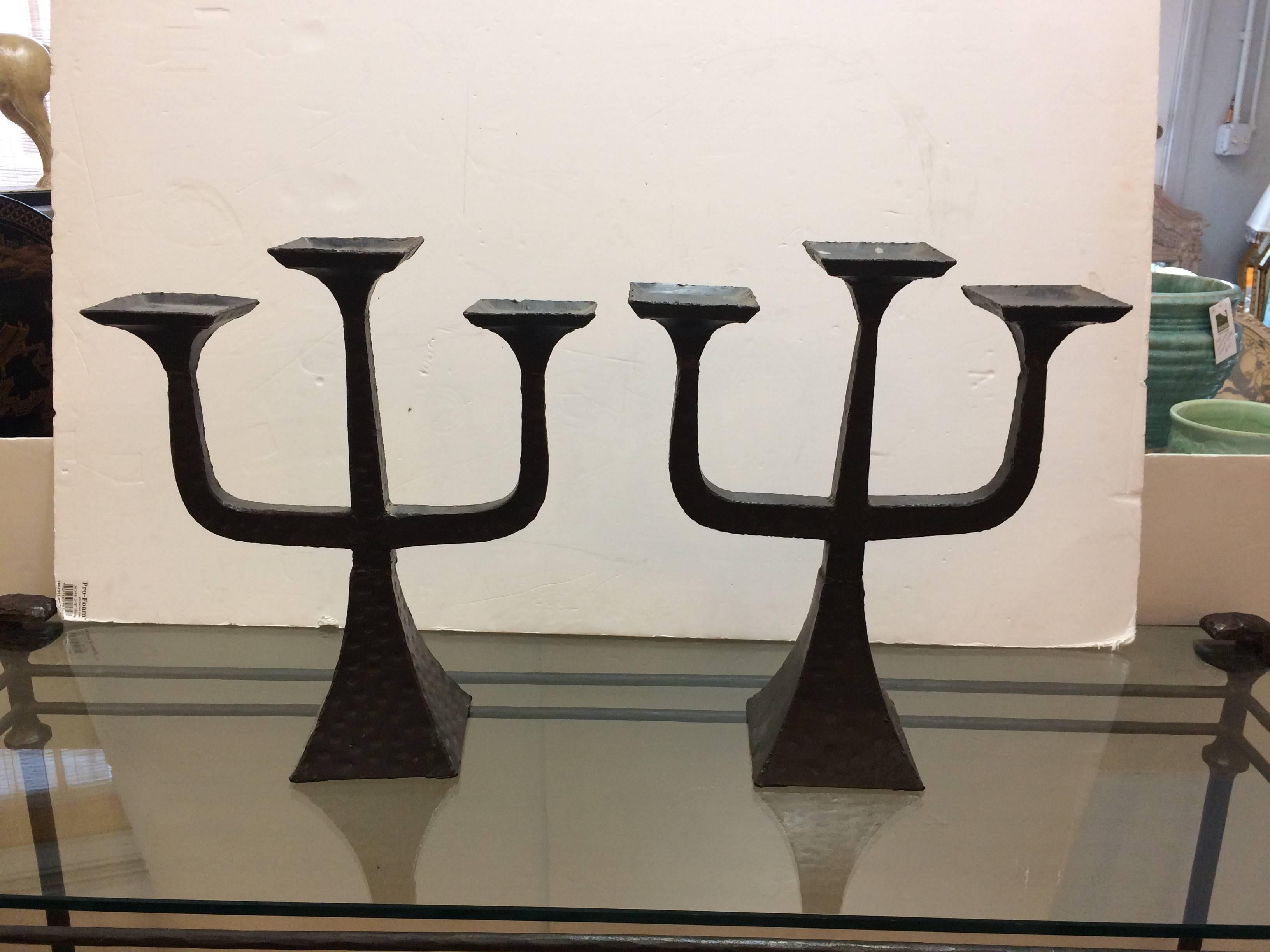 Three chunky hammered metal candelabra in the Brutalist style.
$450 each.