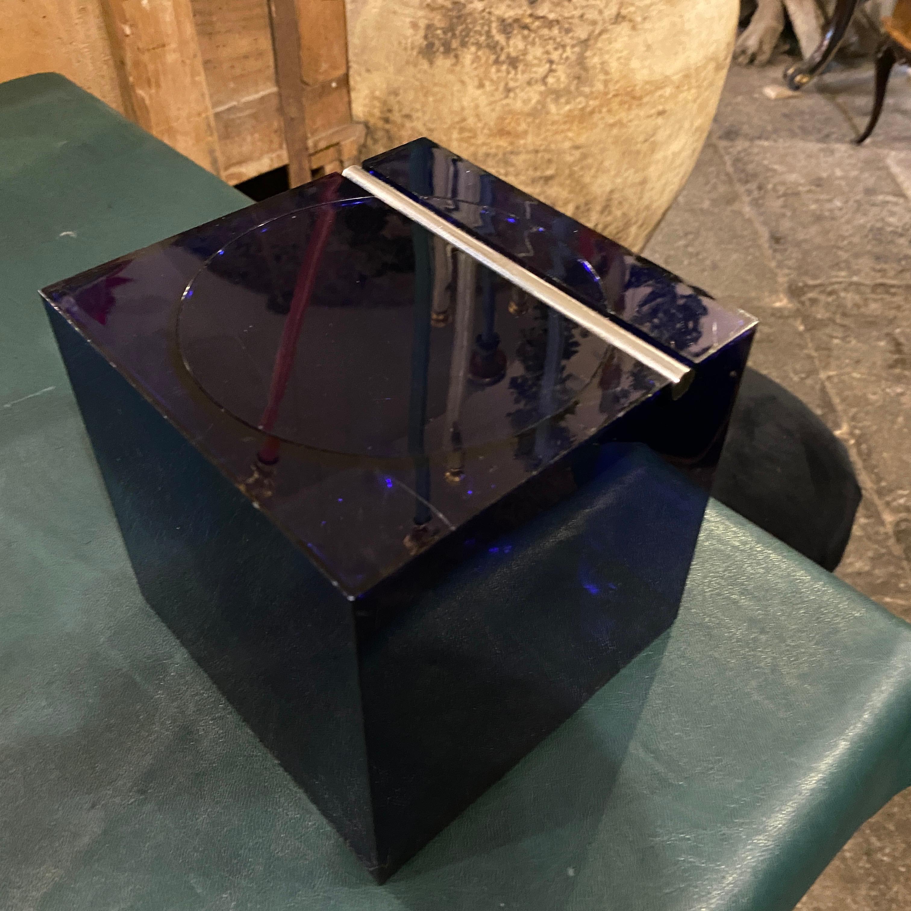 An iconic cube ice bucket made in Italy in the Seventies by Cini & Nils, this version it's in an electric blue acrylic and steel. Studio O.P.I. is an Italian design studio known for its collaborations with various companies to create innovative and