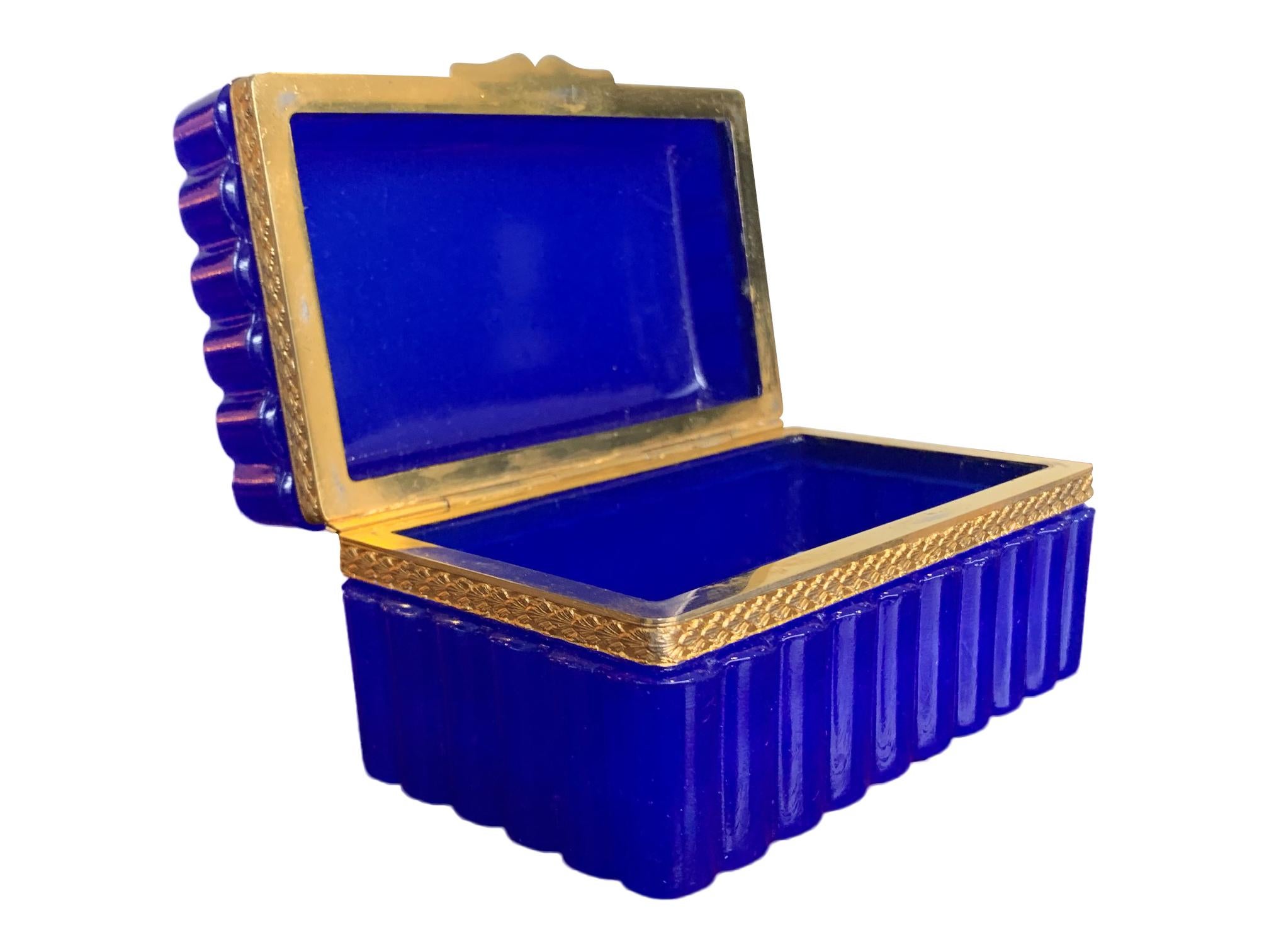 A stunning cobalt blue ribbed Murano glass hinged jewelry box by Giovanni Cendese, Murano Italy with gilt central detail and hinge.

 