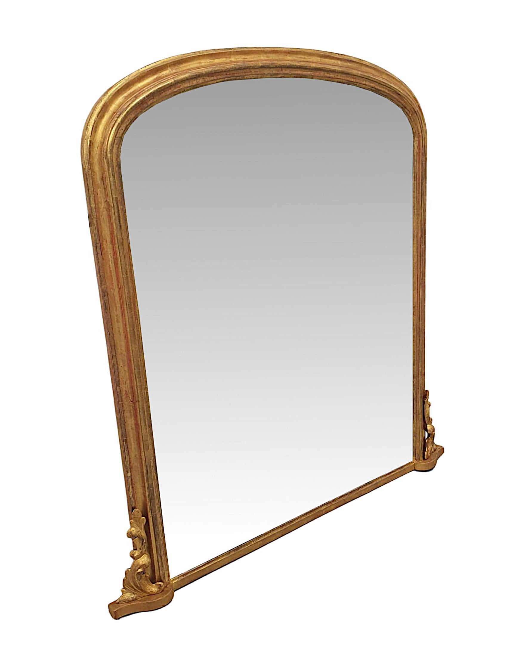 A stunning 19th Century elegantly, simple giltwood overmantle mirror. The mirror glass plate is set within a finely hand carved, moulded and fluted giltwood frame of arch top form, supported on shaped platform base with a gorgeous arrangement of