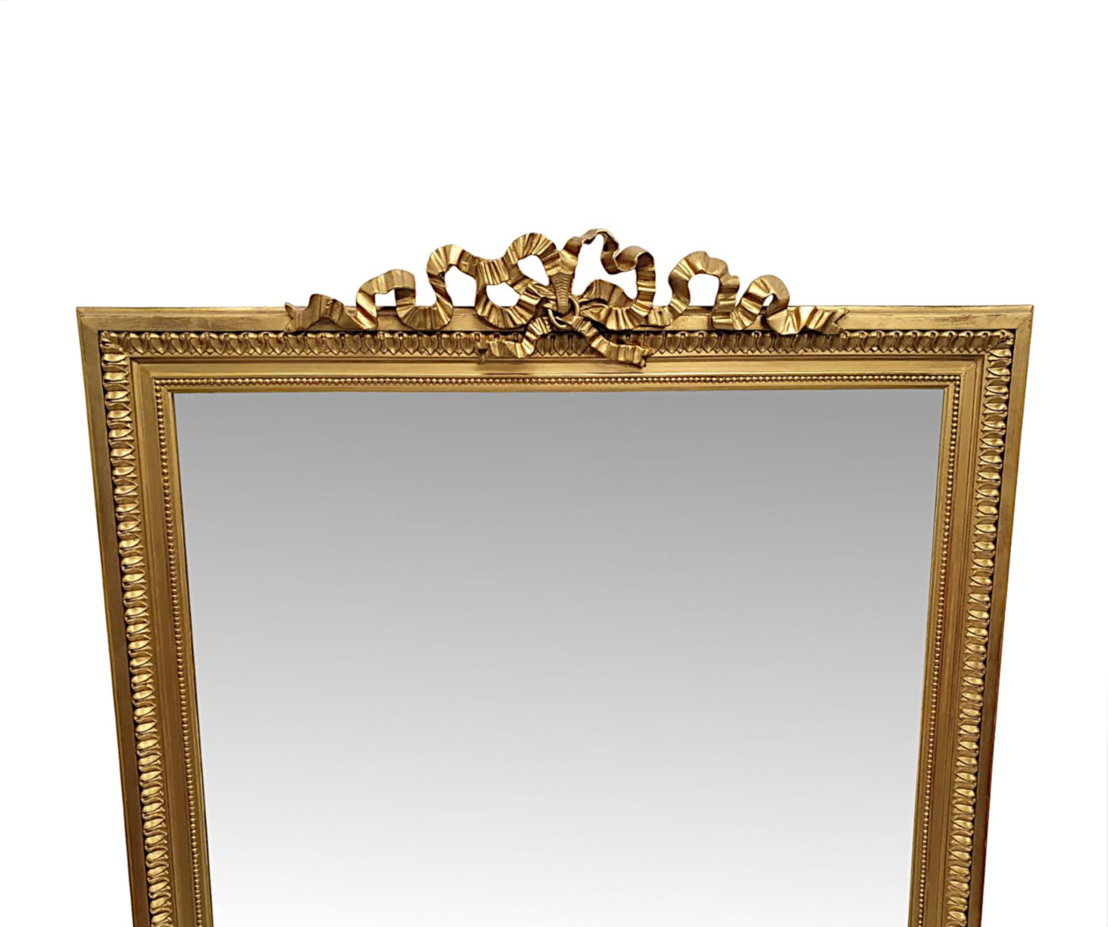 A stunning 19th century giltwood overmantle mirror of large proportions. The mirror glass plate of rectangular form set within a fabulously hand carved, moulded and pierced giltwood frame with gorgeous beaded row and lamb tongue alternating borders.