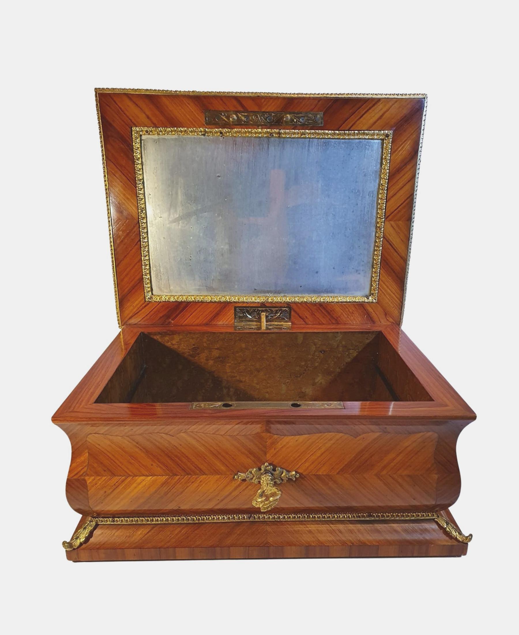 A stunning 19th century kingwood jewellery box with gorgeous ormolu dec-oration throughout, the moulded top of rectangular form beautifully quar-tered veneered and cross banded with central cartouche, opening to reveal fitted section with inset