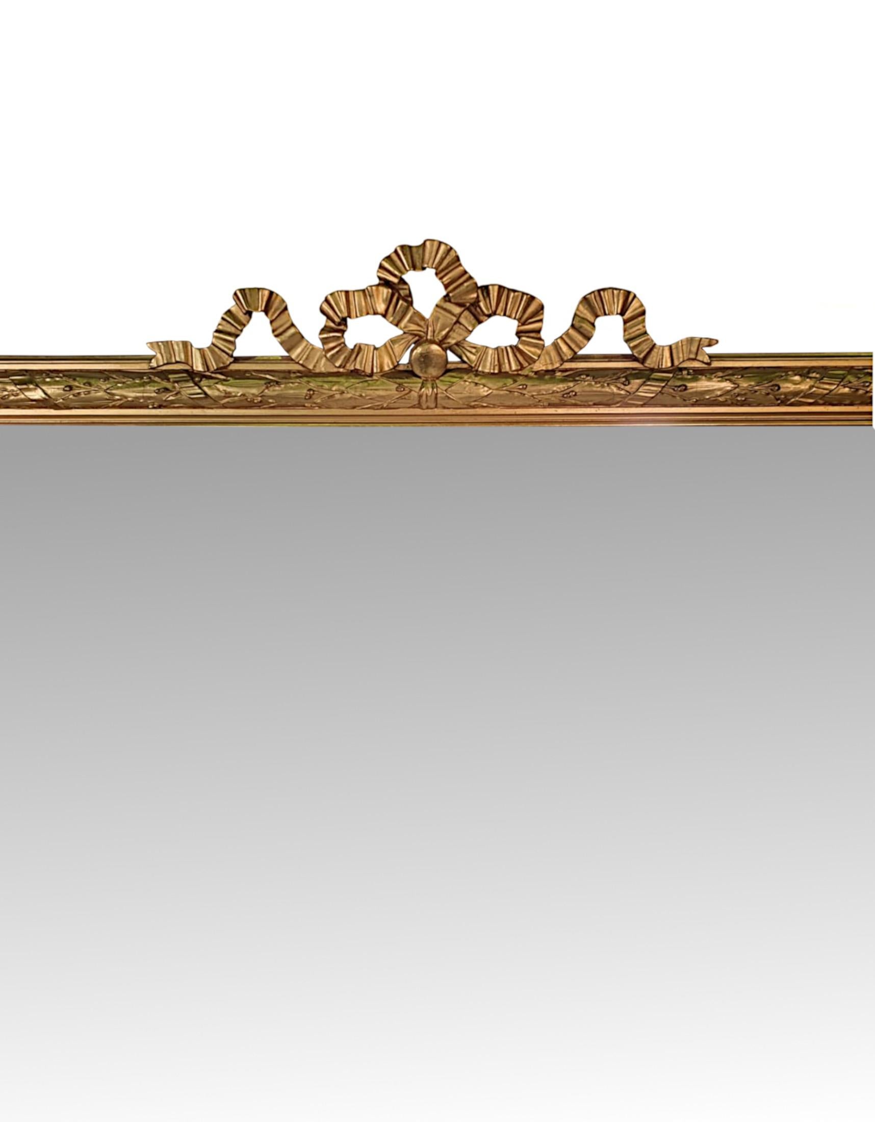 A stunning 19th century giltwood dressing or hall mirror of large proportions. The mirror glass plate of rectangular form set within a moulded giltwood frame with beautiful linen swag, acanthus leaf, foliate and ribbon twist detail, surmounted with