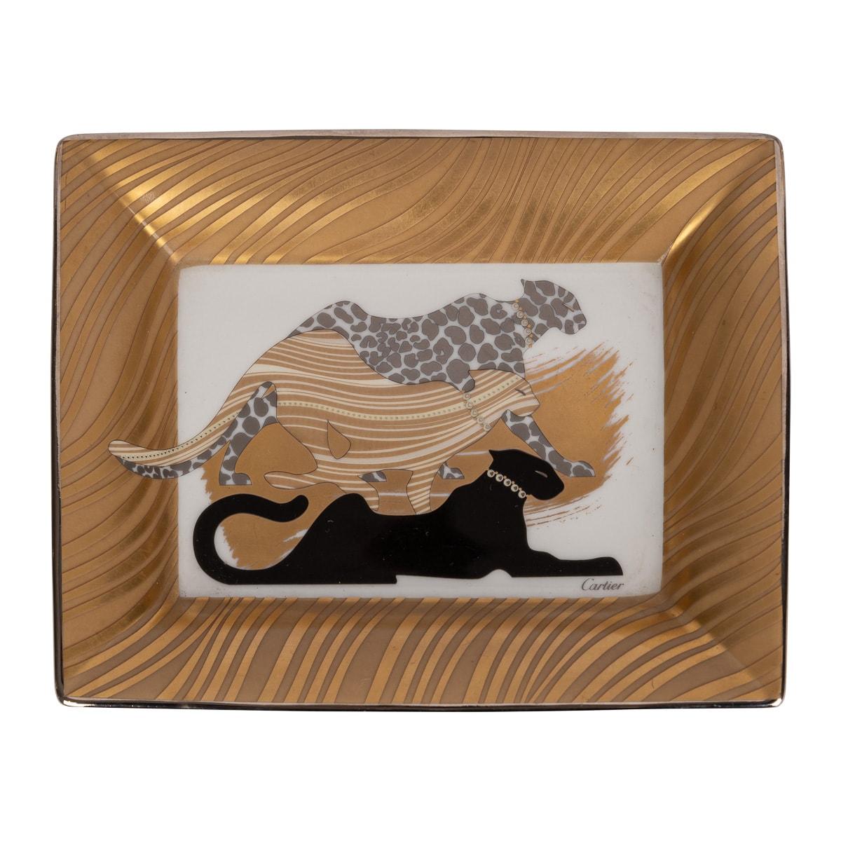 A ceramic ashtray by Cartier, made in France in the latter half of the 20th century. These ashtrays have always been very collectable with the vintage models in particular. This one has a striped gold colour border with three different colour