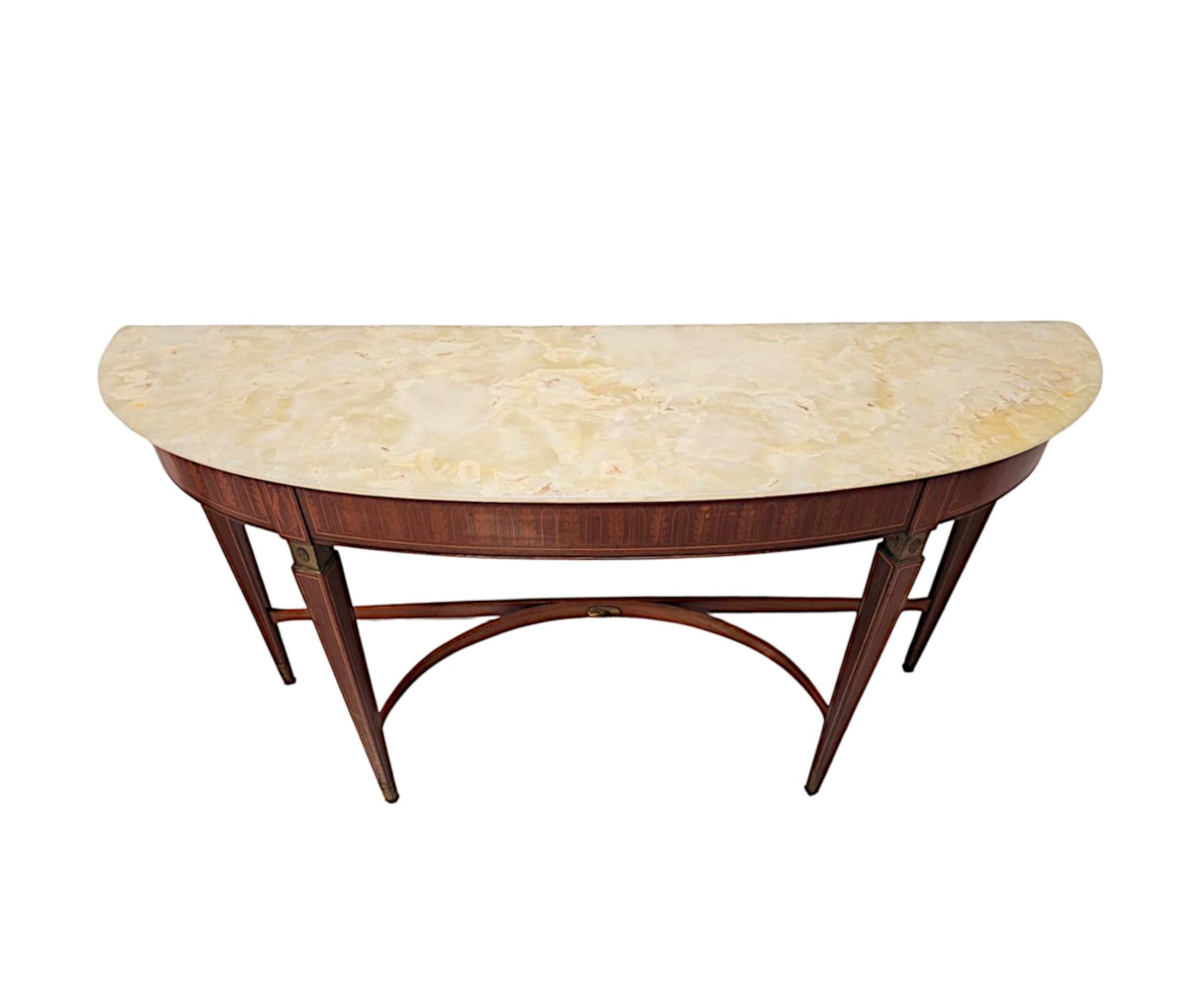 A stunning 20th Century well figured inlaid fruitwood console table of slim proportions, in excellent original condition and of exceptional quality.  This beautiful piece is finely hand carved with rich patination, grain and brass mounted with