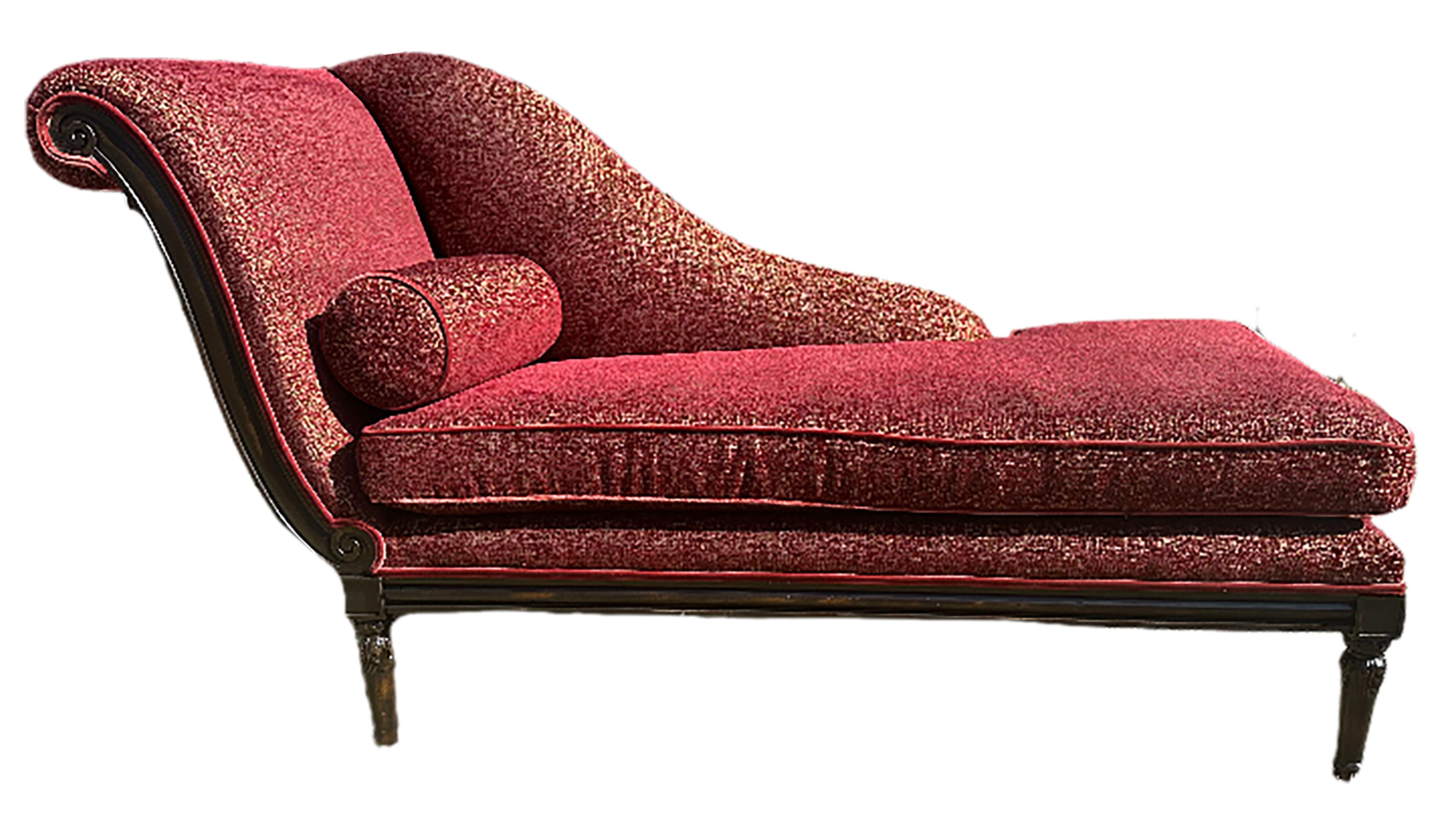 A fantastic, newly upholstered antique chaise longue worthy of Madame Le Recamier. deep reds. The back arches in a sophisticated semi-French curve shape. Includes a round bolster to enhance its comfort. 

In very good condition. Restored ebonized