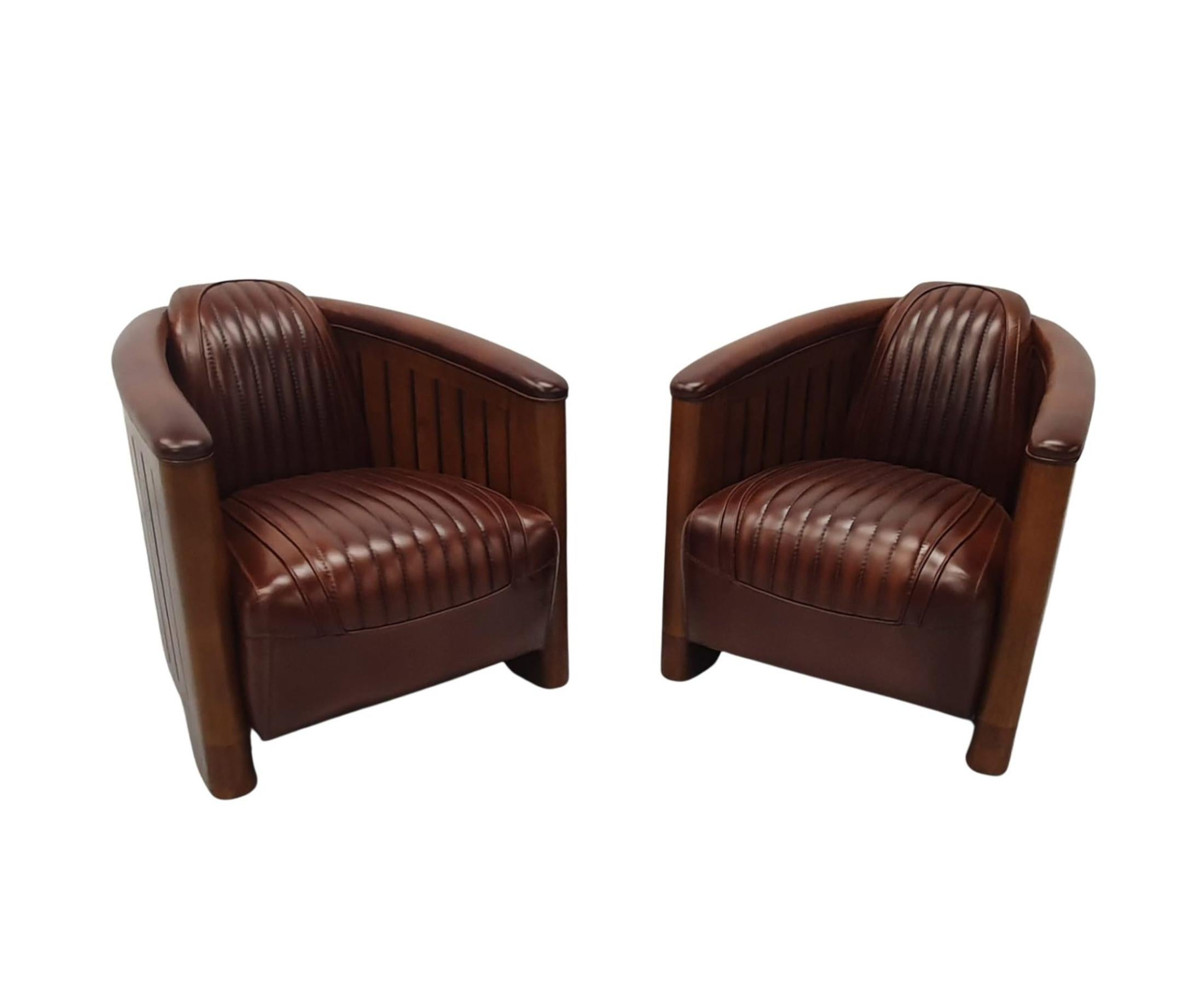 A stunning handmade leather and cherrywood framed club armchair in the Art Deco style, of fabulous quality and with gorgeously rich patination and grain.  Beautifully upholstered in elegant brown leather with innovative horizontal pipe stitch