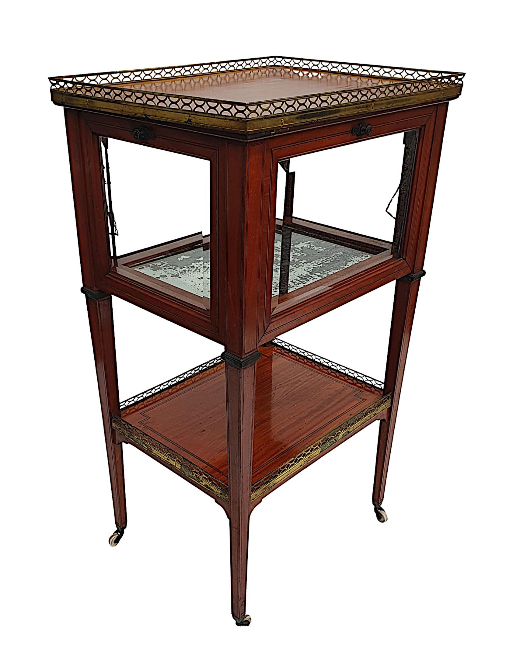 A stunning Edwardian satinwood drinks table with fine line inlay throughout. The moulded top of rectangular form with pierced brass gallery rail raised over four bevelled glass panels which extend downwards, supported on tapering square legs with