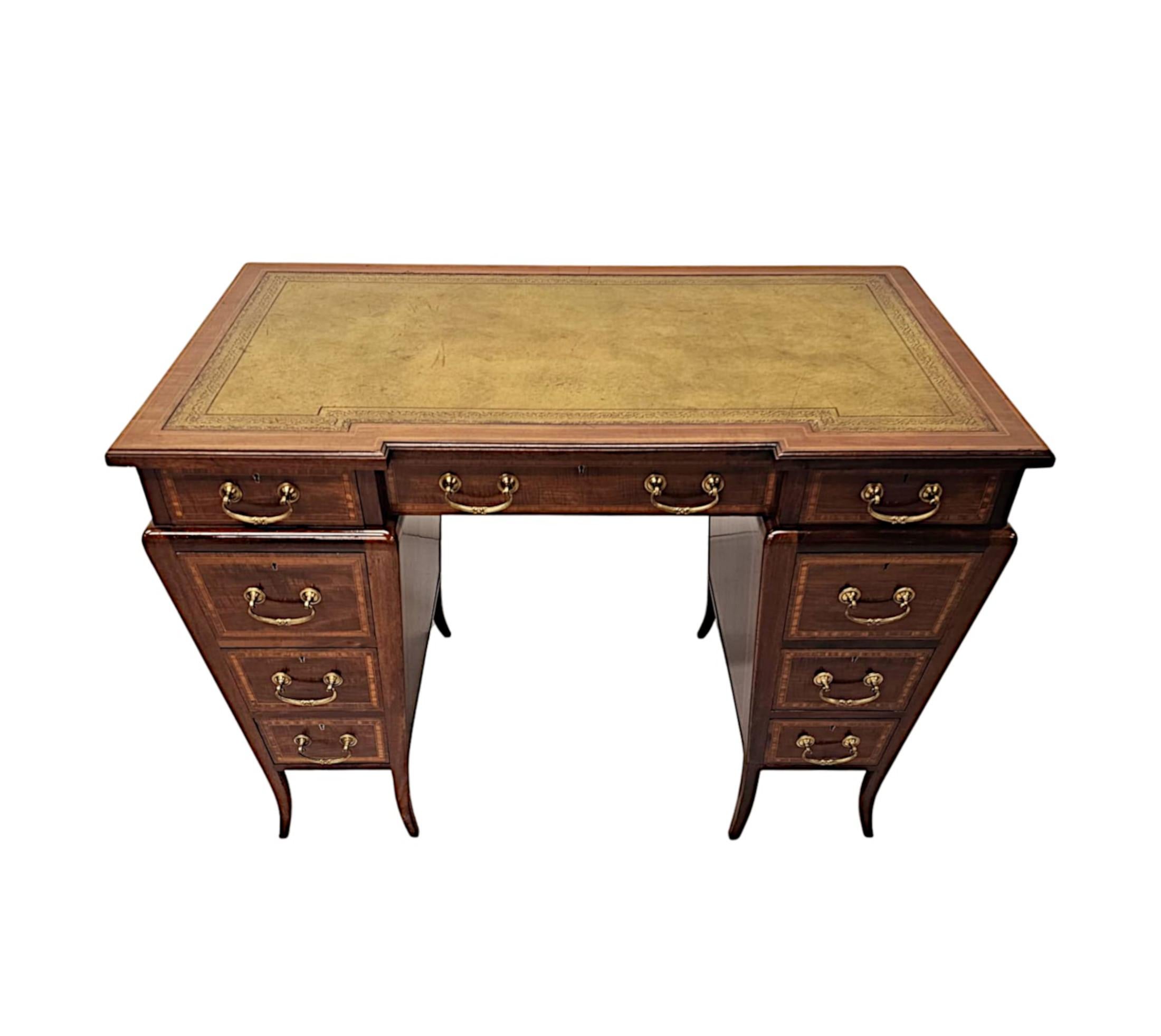 A stunning Edwardian richly patinated and beautifully figured mahogany desk in the manner of Edward and Roberts, London.  This fabulous piece is of exceptional quality, stunningly carved with striking crossbanded detail and delicate line inlay