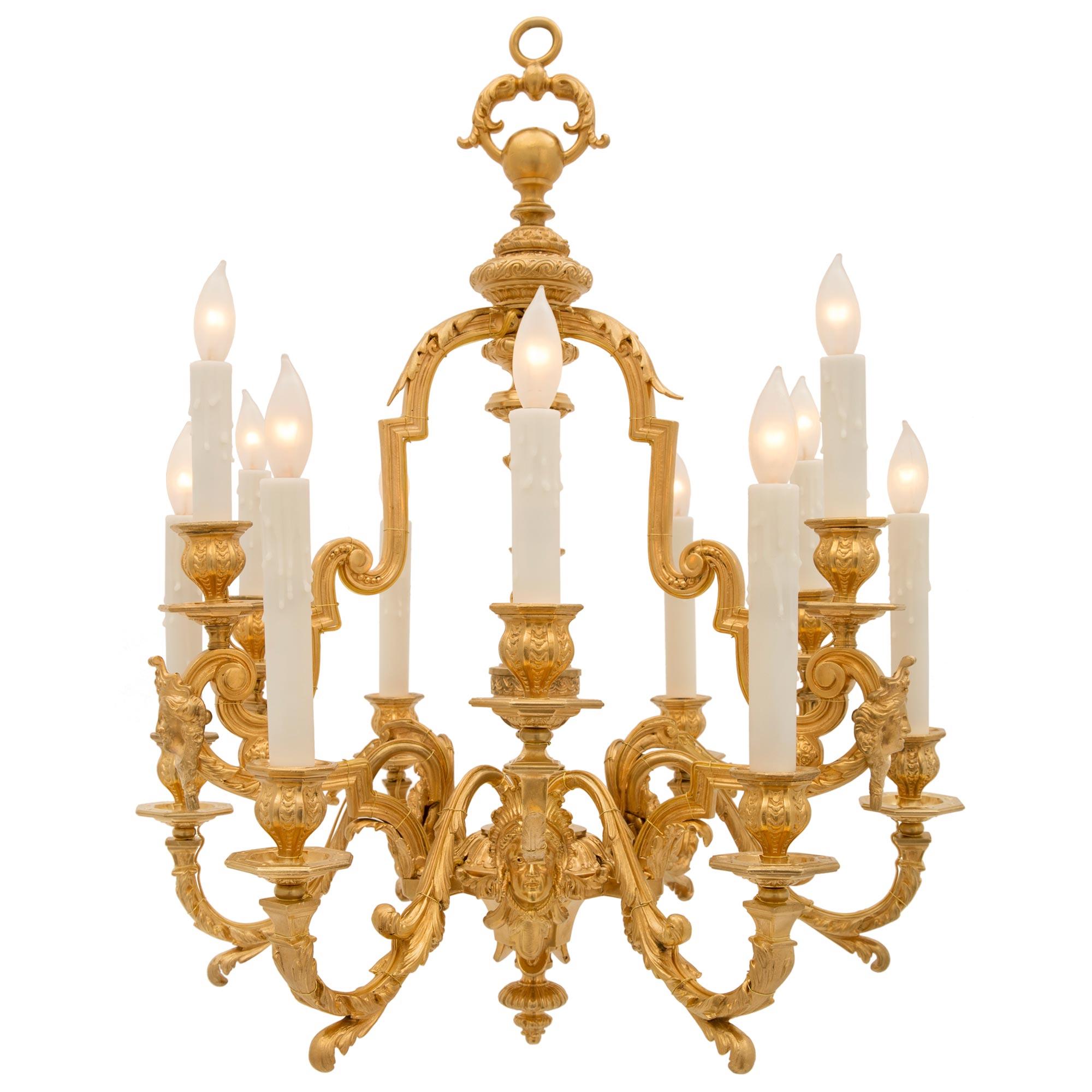 An impressive and most decorative French 19th century Louis XIV st. ormolu chandelier. The twelve arm chandelier is centered by an elegant bottom mottled final below finely detailed foliate designs centered by lovely acorn finials. The twelve arms