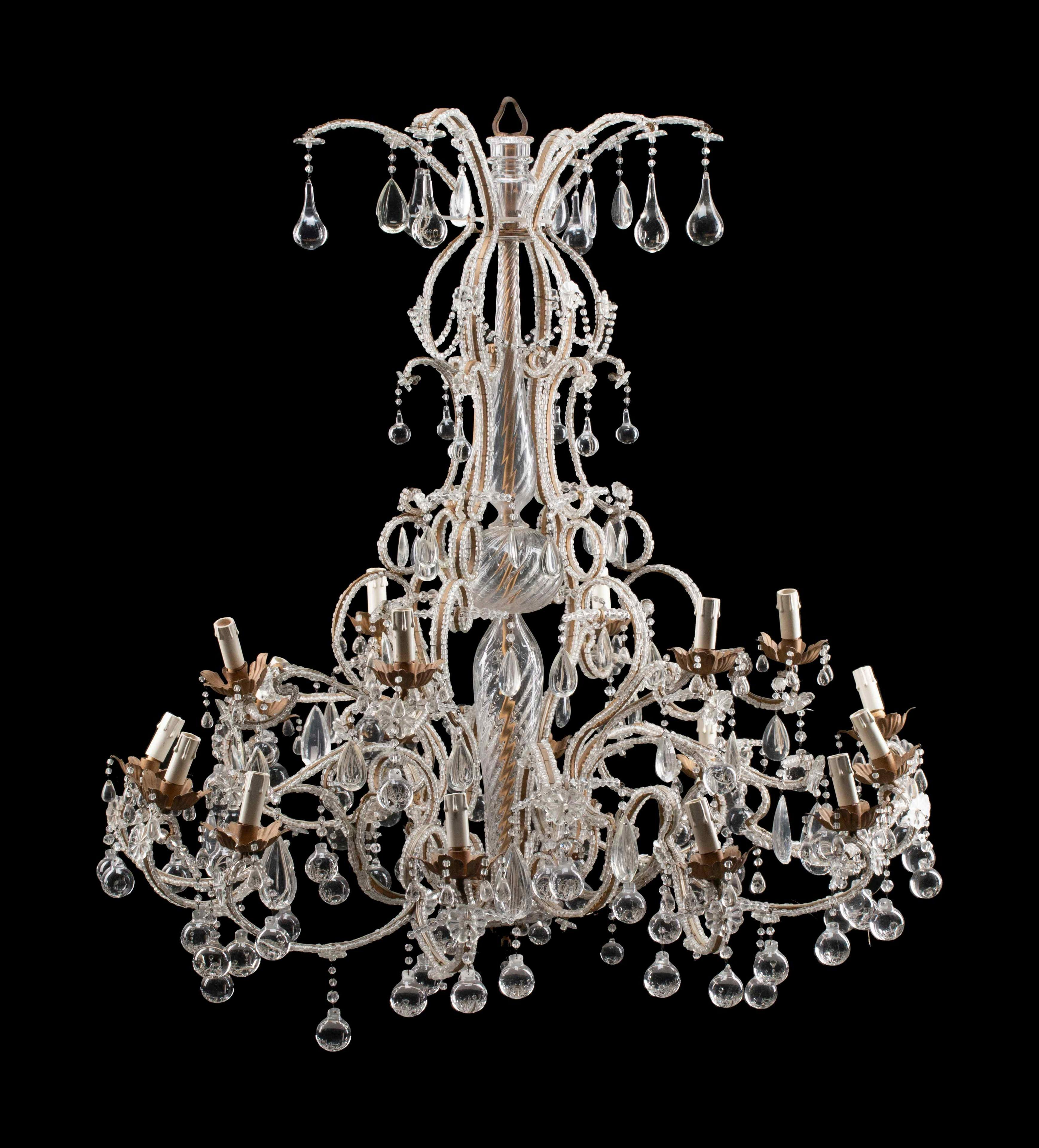 A stunning gilt iron, glass and crystal Venetian chandelier. Eighteen lights distributed in two levels (12 plus 6). In the center, a ballaster shaped crystal shaft, Italy, circa 1910. Measures: Height 49 x diameter 45 inches.
CW4836.