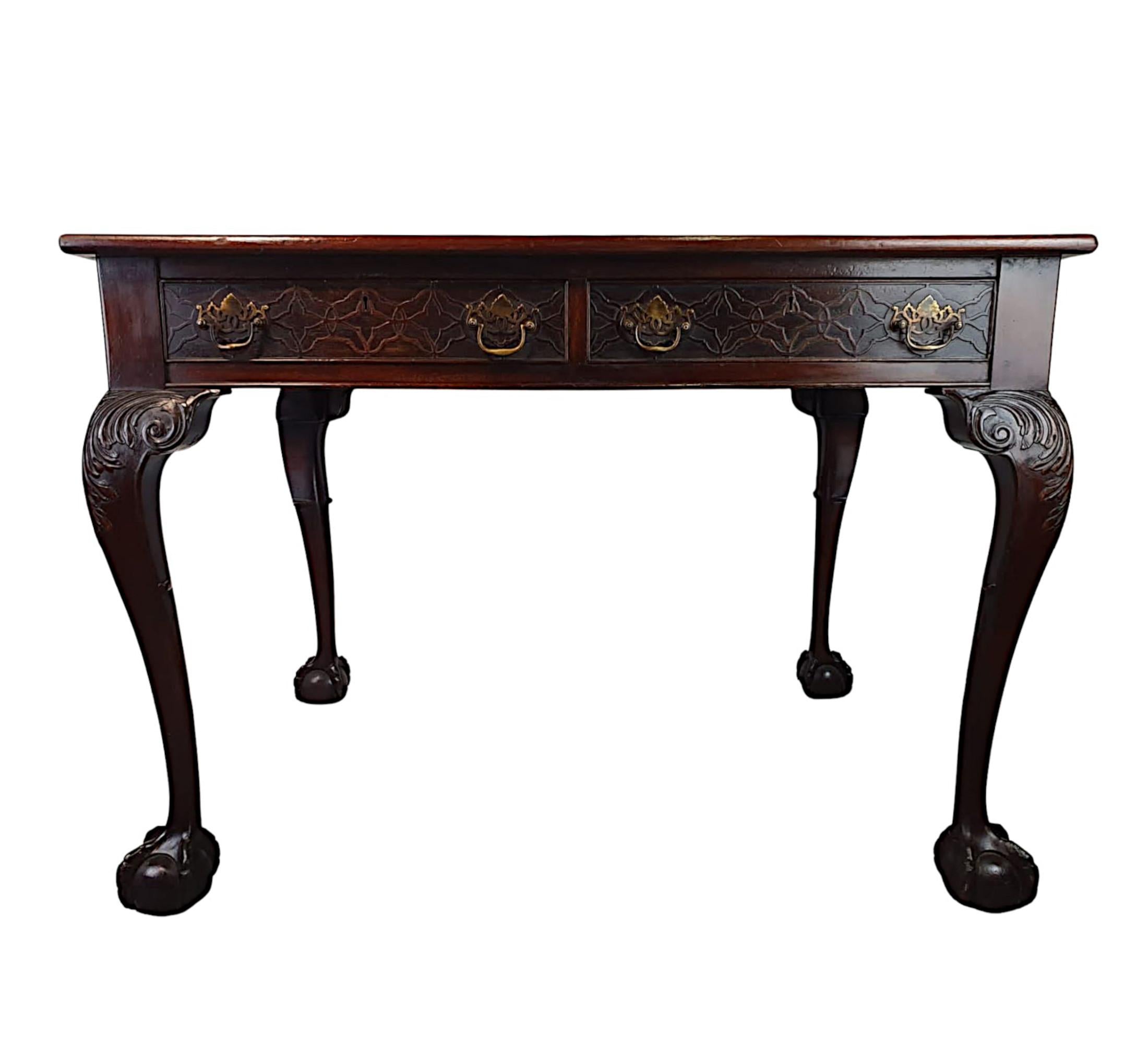 A stunning late 19th century mahogany desk in the Thomas Chippendale manner. The moulded top of rectangular form fitted with green gilt embossed tooled leather writing skiver surface, raised over frieze with two drawers with beautifully carved blind
