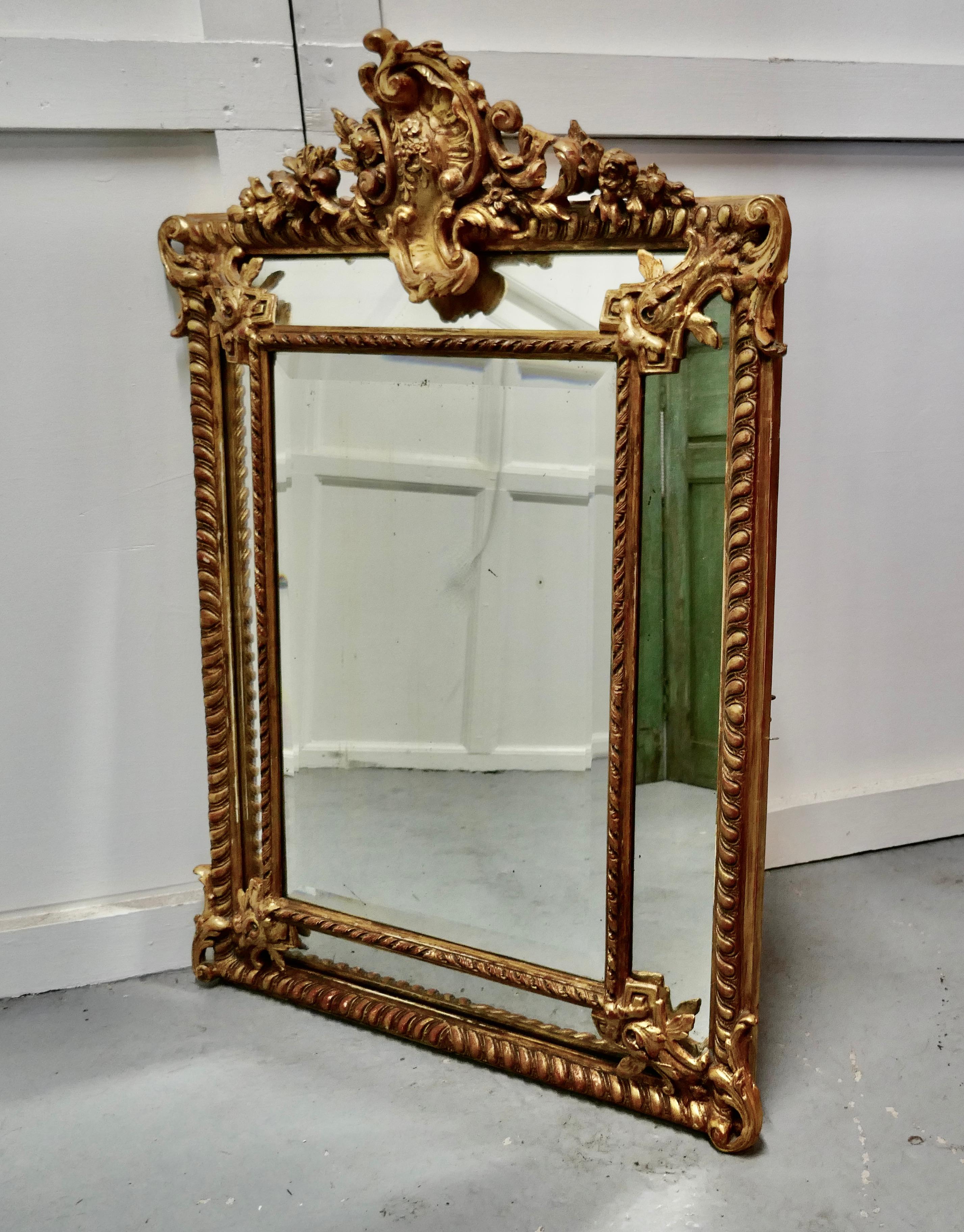 A stunning Napoleon III French cushion mirror

This is an exquisite piece a fine example of mirrors of this type, the centre glass is framed with smaller angled mirrors all around 

There is an elaborate gesso and gilt shell crest on the top of