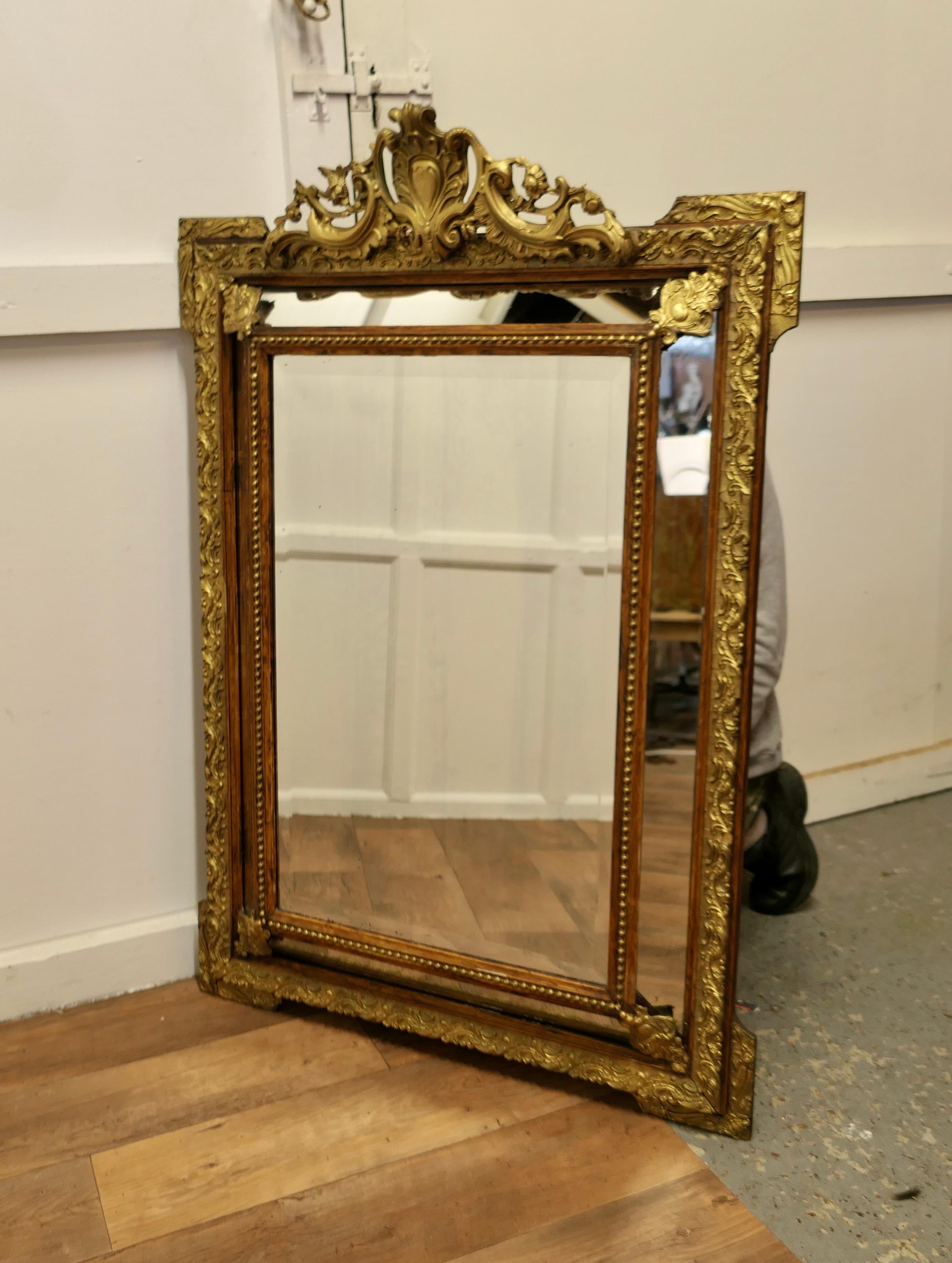 A Stunning Napoleon III French Cushion Mirror

This is an exquisite piece a fine example of Mirrors of this type, the centre Glass is Framed with smaller angled mirrors all around 

There is an elaborate Gesso and Gilt Crest on the top of the
