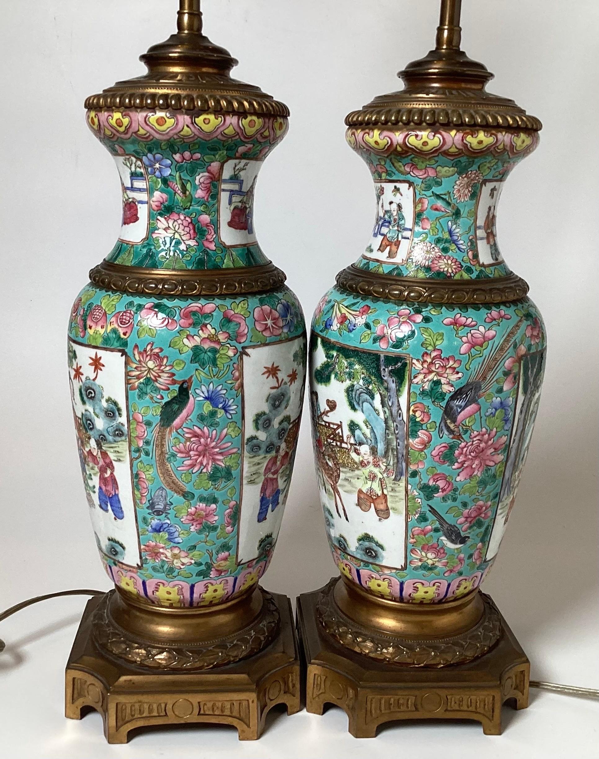 A remarkable pair of early 19th century hand painted Rose Mandarin Chinese Export porcelain vases now as lamps. The vases are pre-1850 and lamped in the 1920's with elegant gilt bronze mounts. The porcelain vases are original mirror image to each