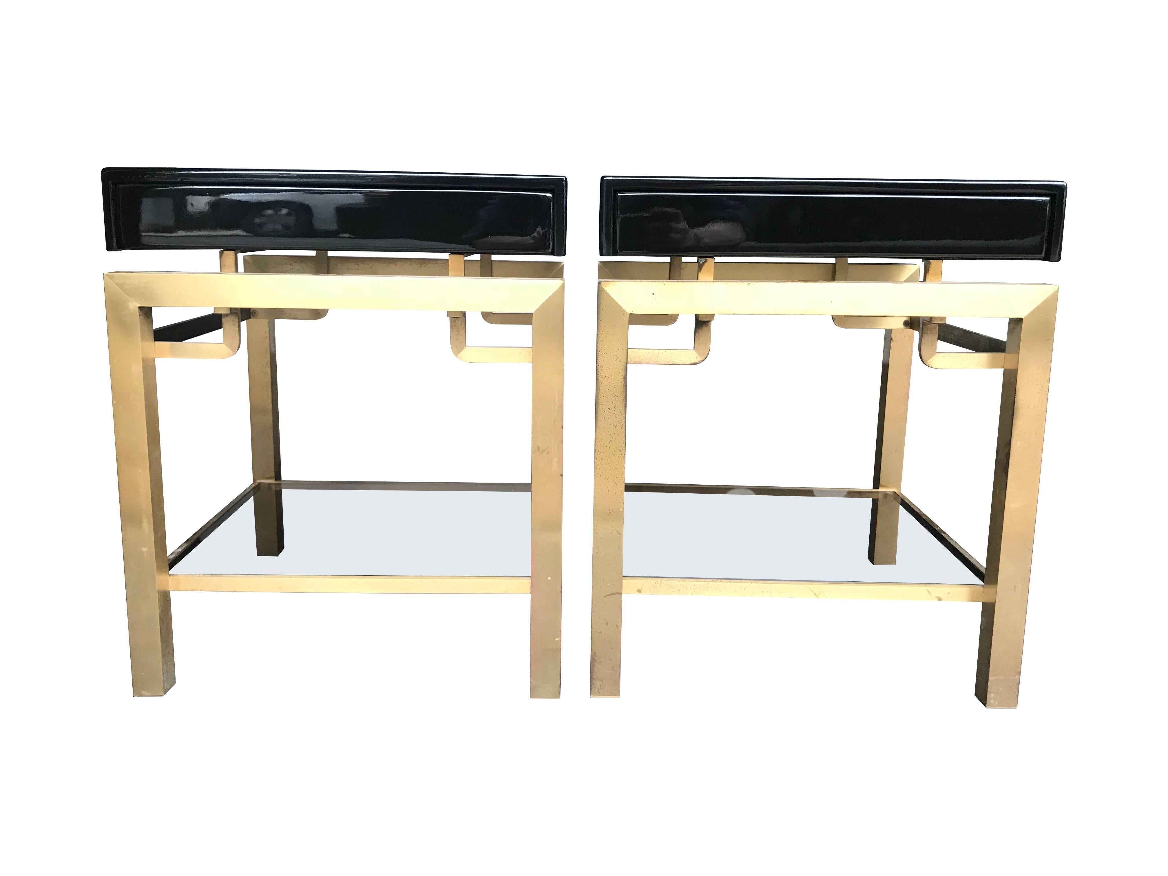 A stunning pair of Guy Lefevre designed side tables for Maison Jansen with gilt metal legs and black lacquer top, each with a single drawer.