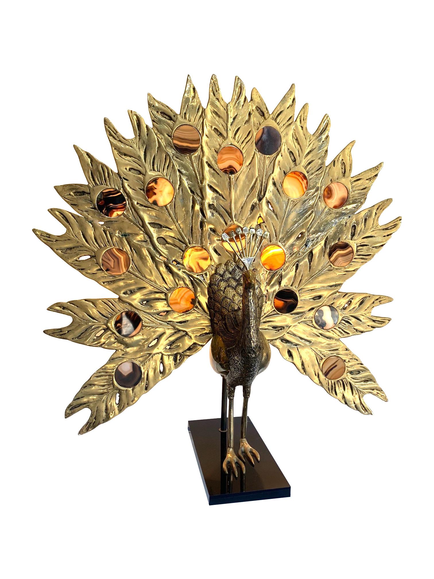 A stunning rare 1970s large brass Peacock lamp with backlit agate tail feathers by Fondica France. The tail feathers are backlit with a two bulb fitting. This piece came from a distributor for Fondica and this was part of his stock, so was never