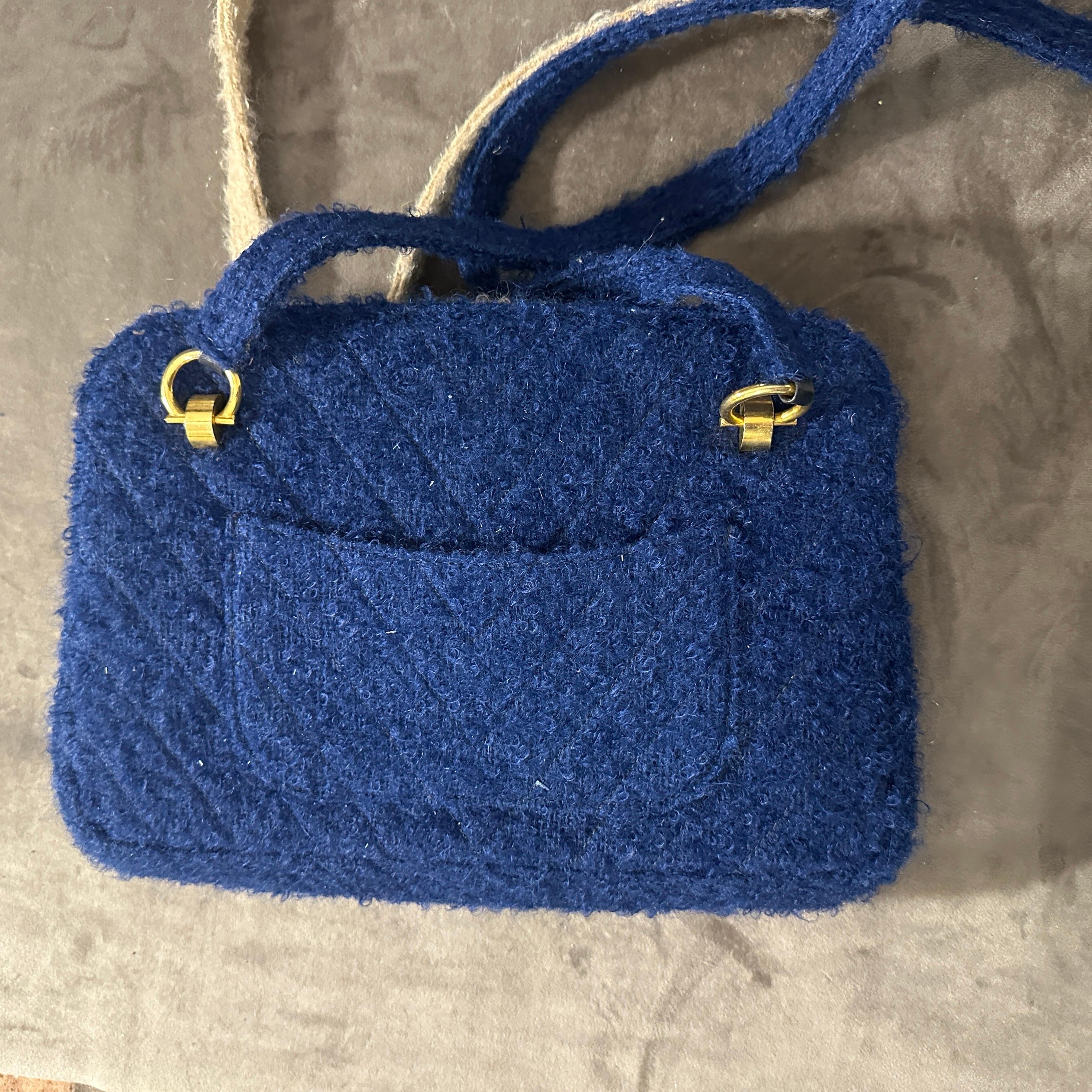 This unique 1970s vintage Italian shoulder bag combines classic craftsmanship with a distinct double-face design. Featuring contrasting textures, one side is rendered in a creamy white fabric with a soft, boucle-like finish, complete with a front