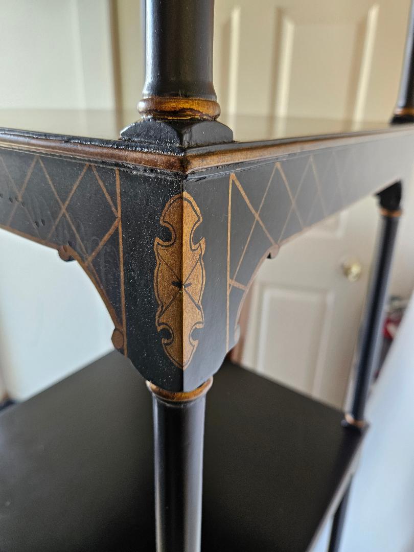 A hand painted chinoiserie etagere by Chelsea House. The three tiers graduated from top to bottom, with black background with painted Asian inspired decoration.  69 inches tall, 19.5 inches square at the bottom. 