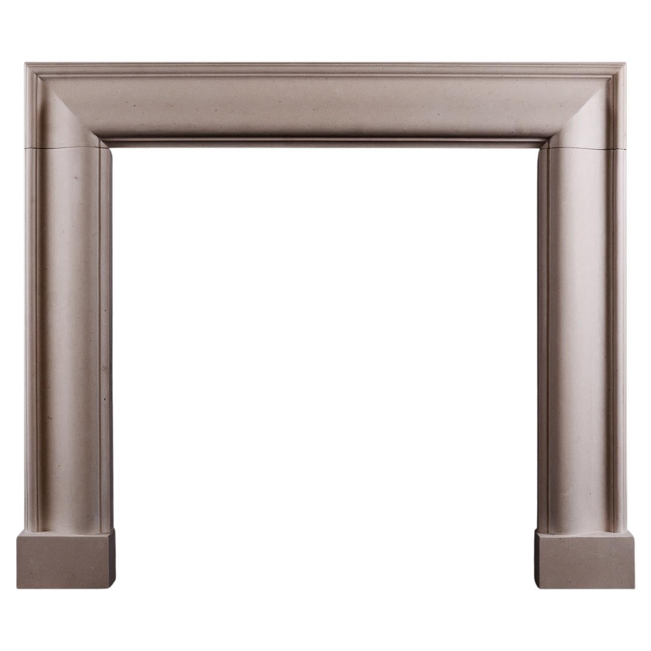 A Stylish English Moulded Bolection Fireplace in Moleanos Limestone. For Sale