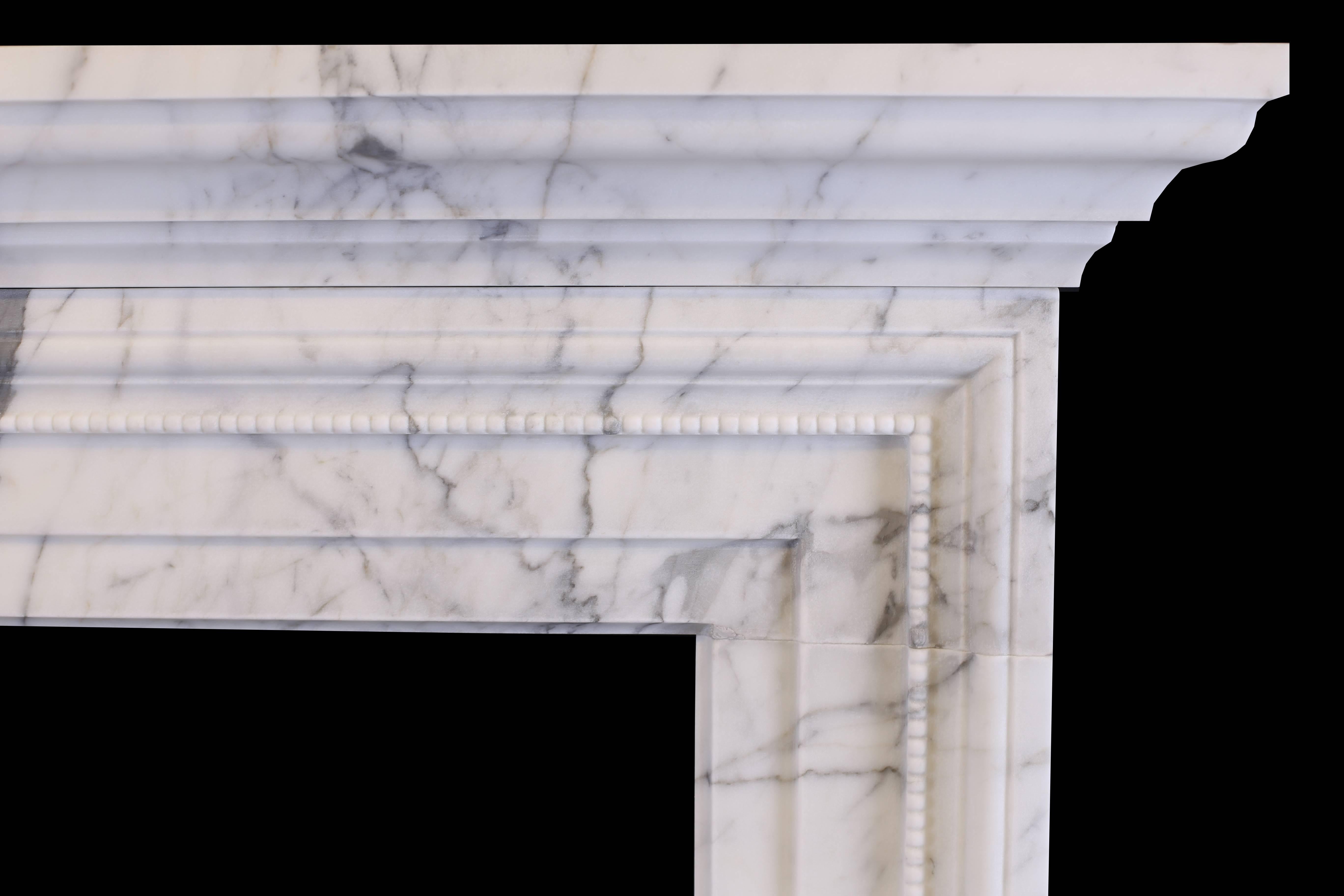 A stylish English Regency bolection chimneypiece in high quality Italian white statuary marble, moulded frieze and jambs of architectural form and the inner moulding with beading, also with grand moulded shelf above.

Measurements:
Depth 4 1/2 in