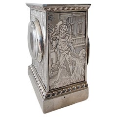 A sub miniature  engraved Silver Carriage or Boudoir Clock by Gubelin in case