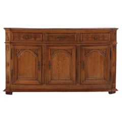 A substantial French or Belgian carved oak sideboard or buffet, 18th C.