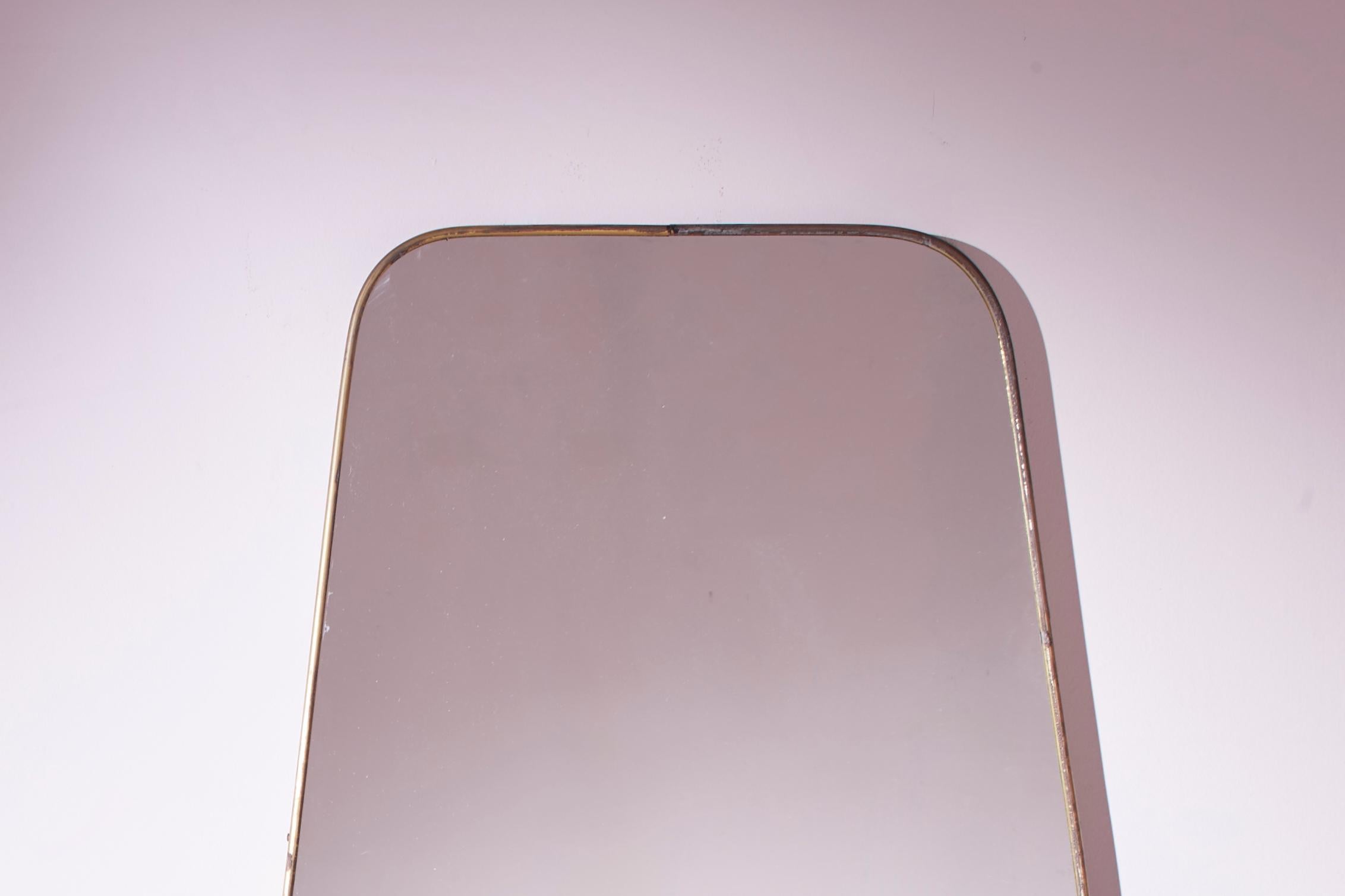 Italian A substantial midcentury modernist wall mirror with brass frame, Italy, 1950s For Sale