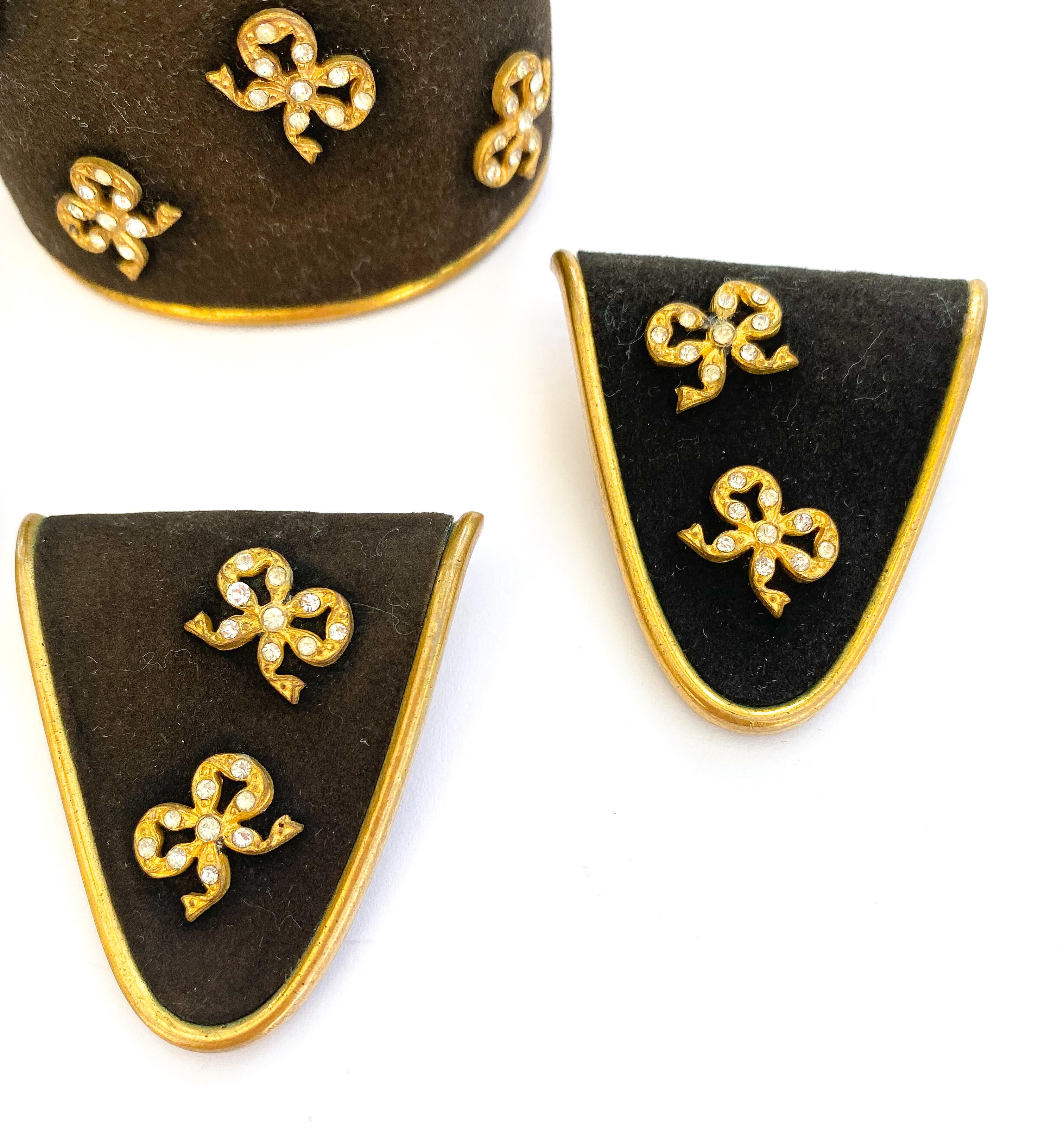 An immaculate and charming black suede and gilt metal suite of jewellery, highlighted with clear paste highlights by Henri de la Pensee from the 1930s - a hinged cuff, two clips and earrings. A classic example of this distinctive brand with
