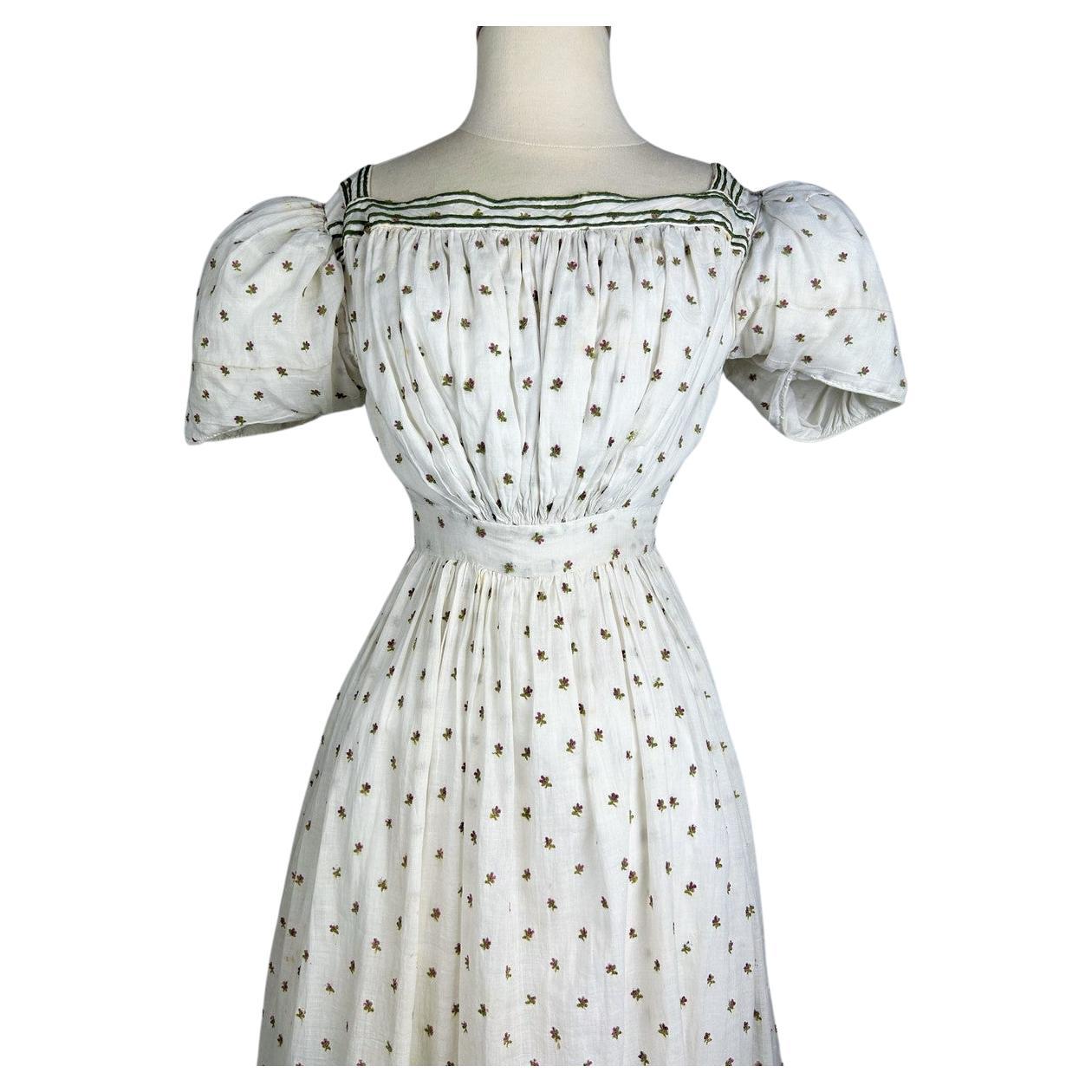 Circa 1820-1825
England or Europe

Interesting summer dress in cotton muslin embroidered with wool circa 1820/1825 from the late Regency period in England. It is reminiscent of the work of Jane Austin.  Bustier with large square neckline applied