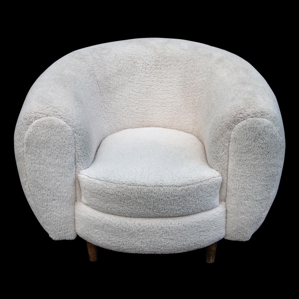 Original sumptuous armchair of broad, generous scale. Iconic in form and inspired by the famous leading french designers of the time, specifically the emblematic Jean Royère ‘Polar bear’ armchair which was launched in 1949.  This model having