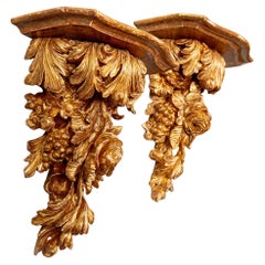 A sumptuous pair of George III carved giltwood wall brackets