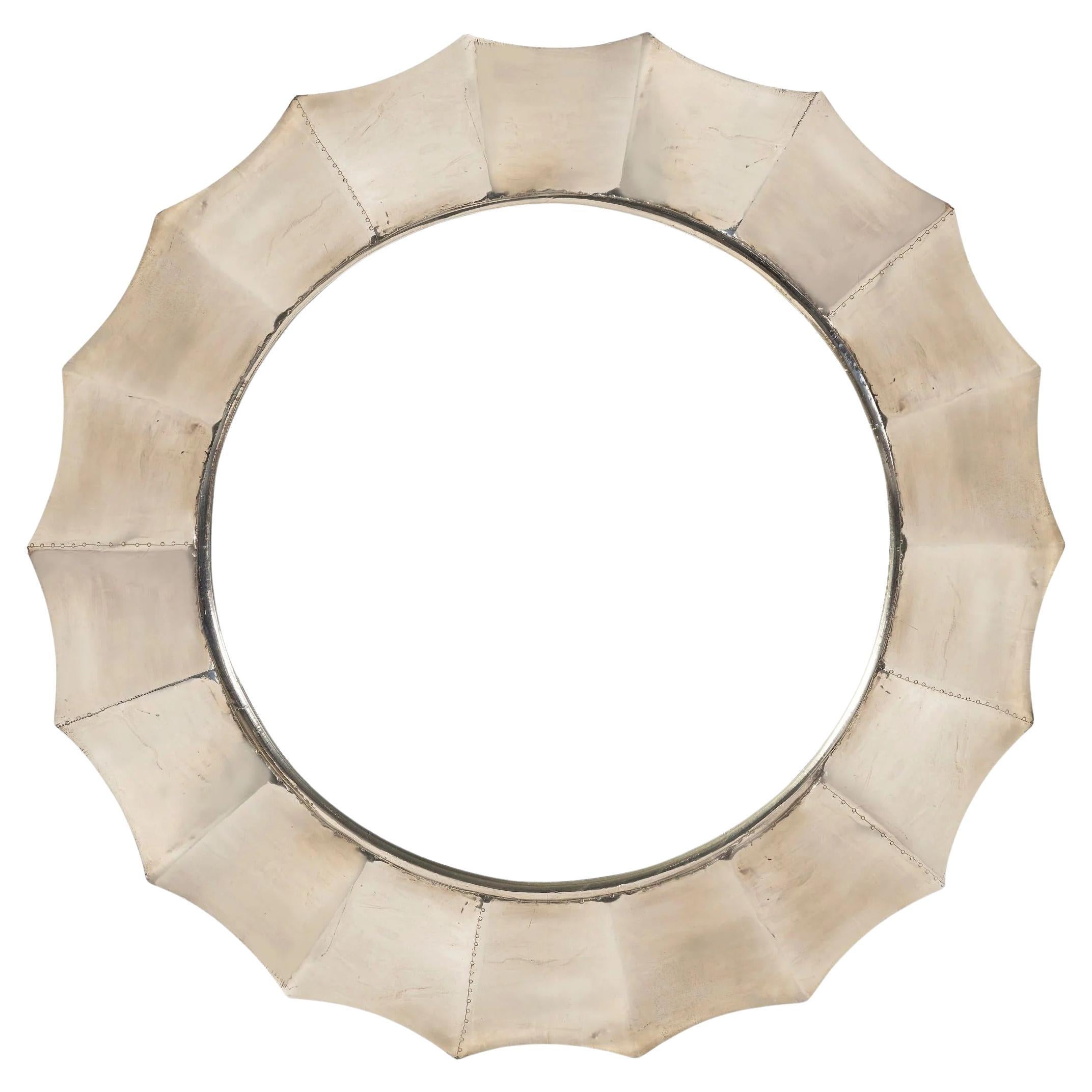A Sunburst Mirror with Pressed Metal Overlay