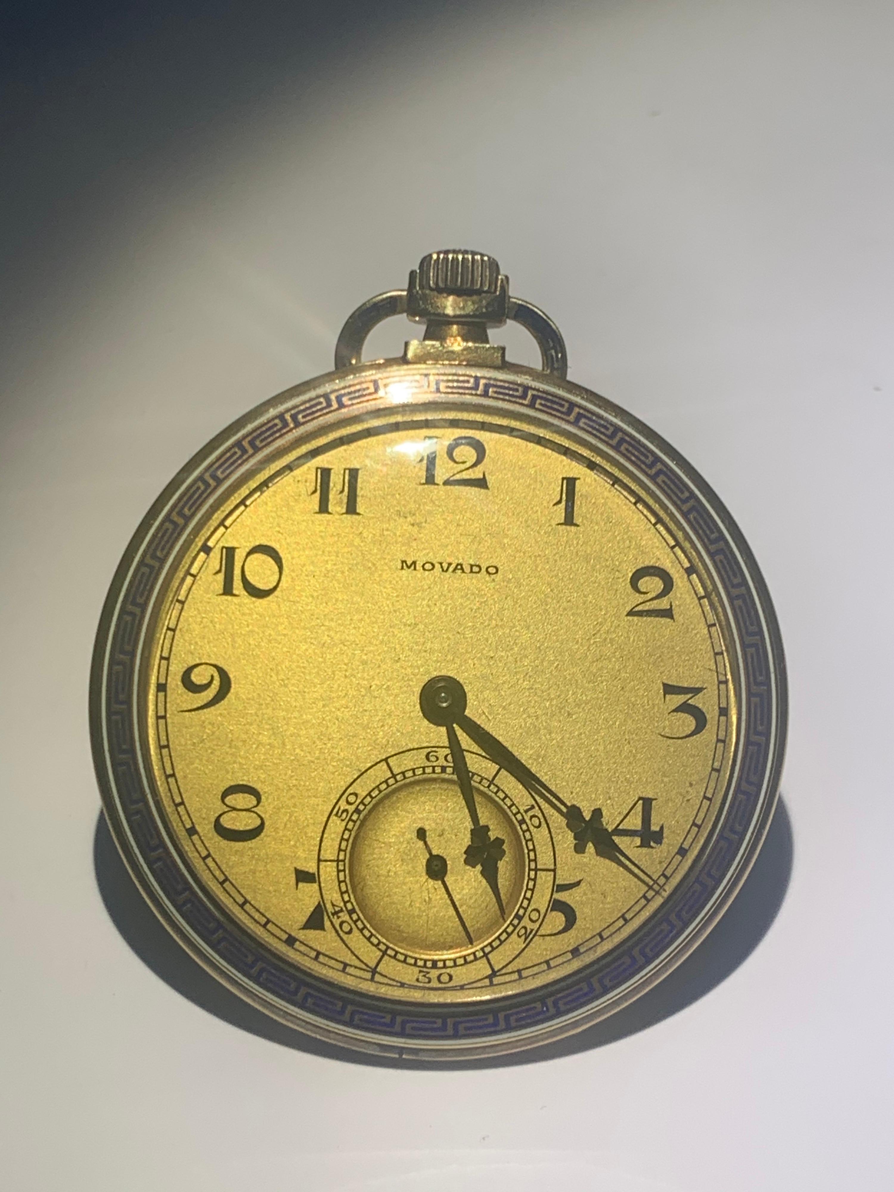 A Superb 14k yellow Gold Art Deco open face pocket watch. Made by Movado. A champagne signed enamel dial 