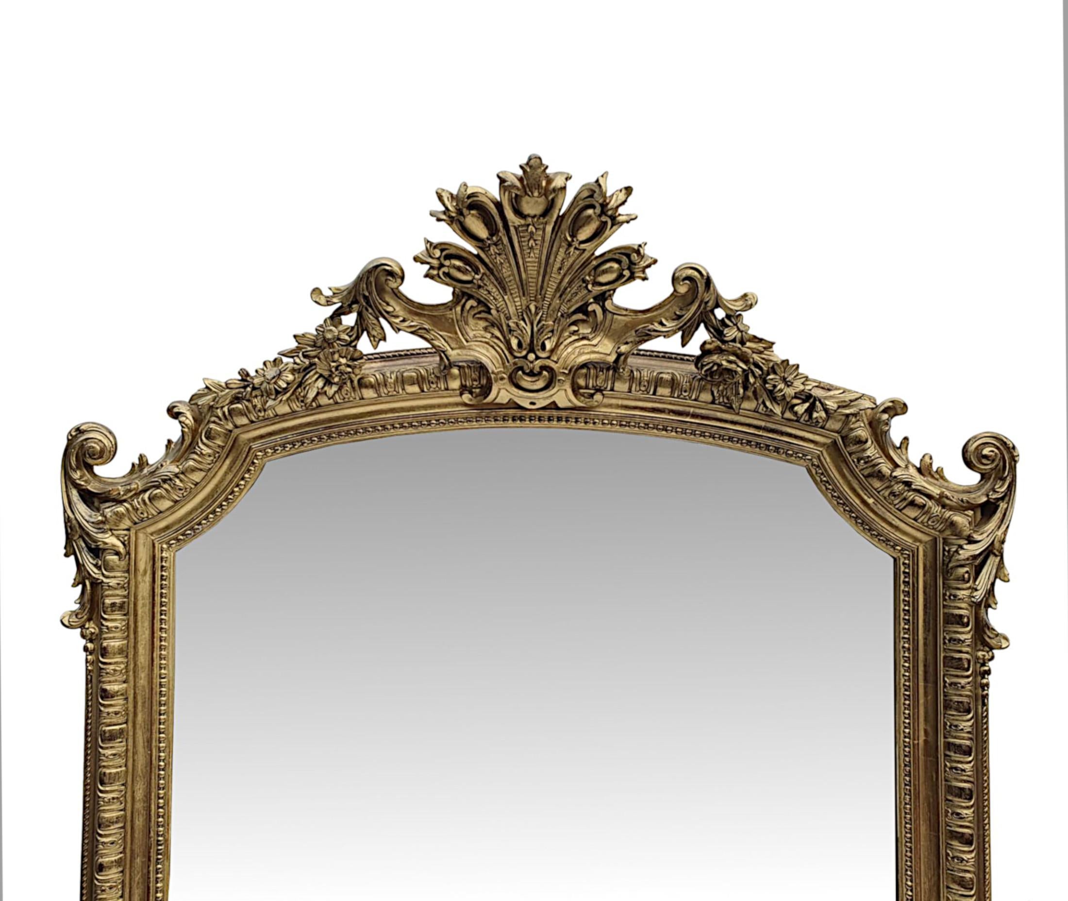 A superb 19th Century giltwood overmantle or hall mirror. The mirror glass plate is set within a beautifully hand carved giltwood frame with lozenge and dart moulding with beaded detail, surmounted with an exquisite cartouche with stylised central