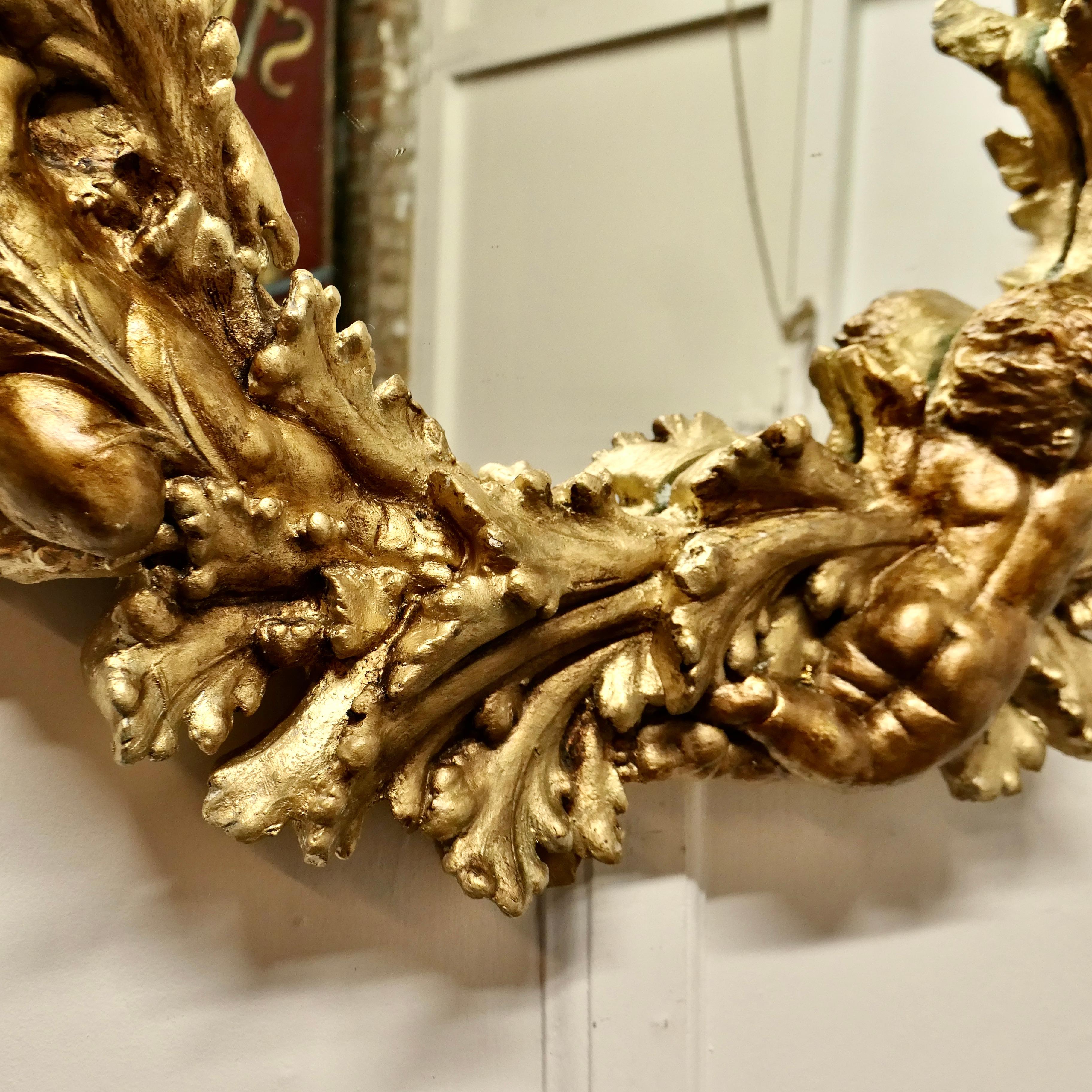 A Superb 19th Century Italian Gilt Wreath Mirror

This is a charming piece, the Mirror has a Gilt frame., which has a very elaborate 9” wide circular frame mounted with Cherubs and Acanthus Leaves
An enchanting piece especially for the festive time