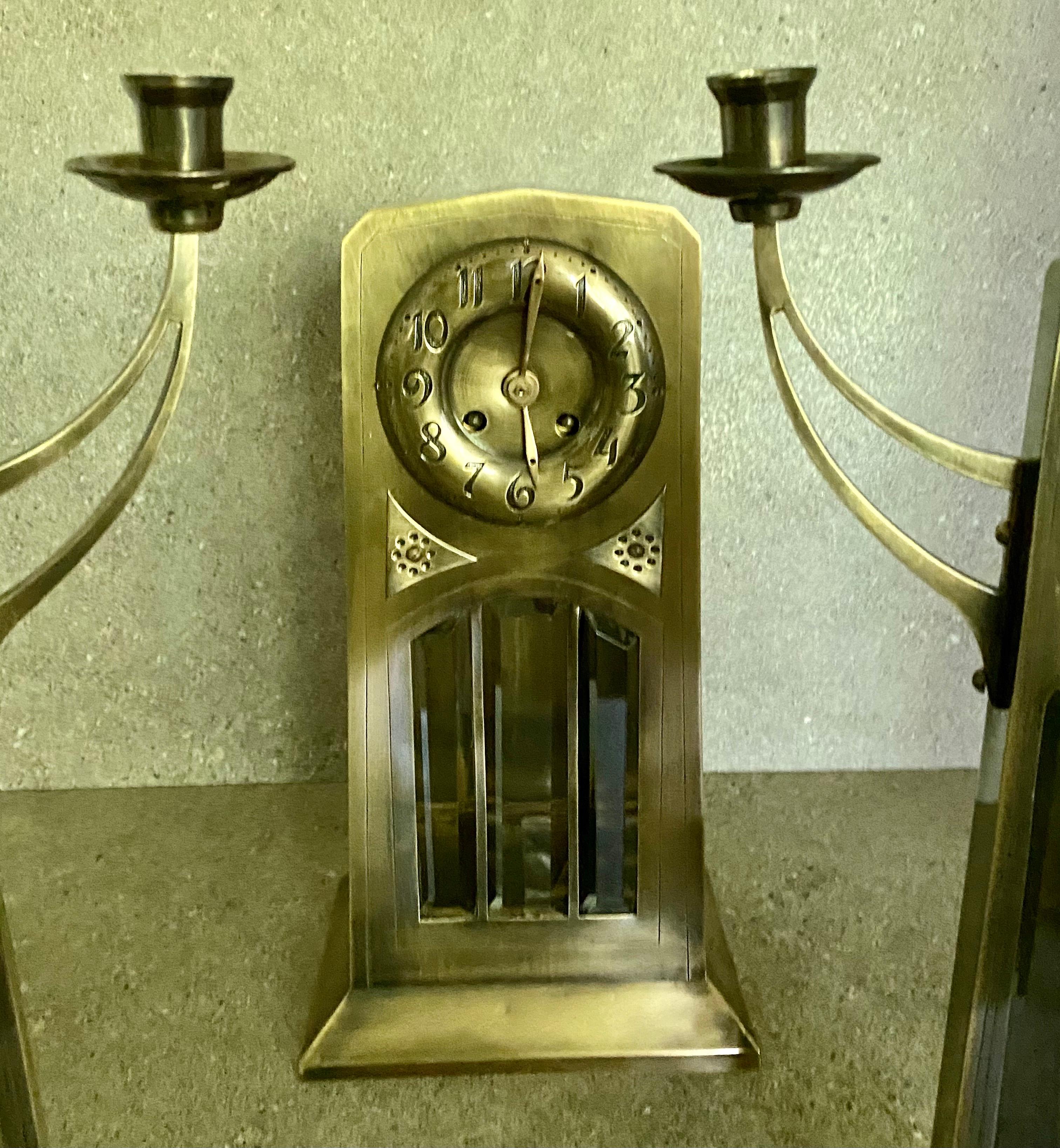 A large Art Nouveau continental brass cased mantel clock, the case having three bevelled glass panels, with a dial, with black numerals, The eight day movement striking on a bell, stamped with maker's Japy Freres & Cie., 37cm tall. This has a