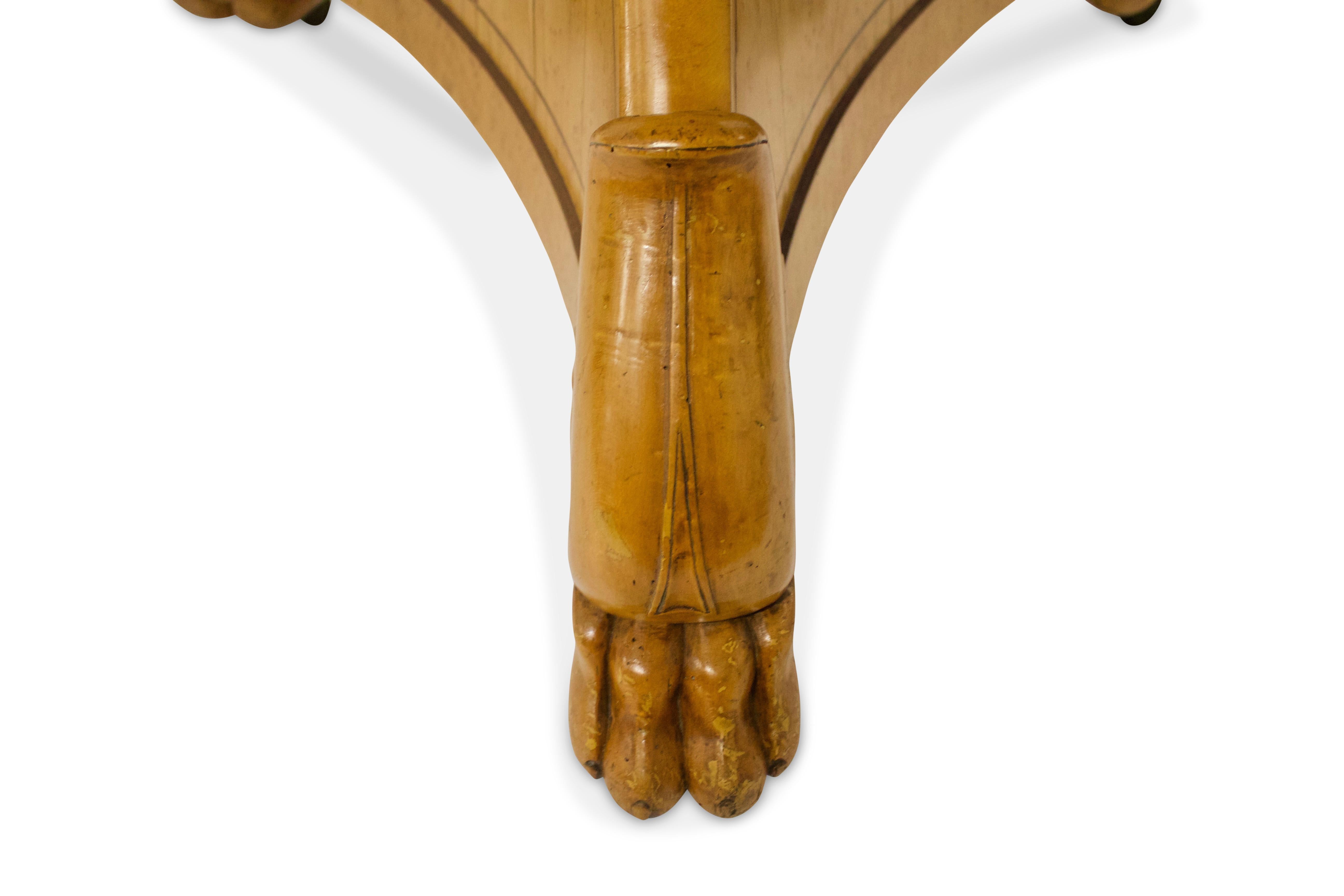 The black grey “St-Anne” marble-top above a bird’s-eye maple gueridon with rosewood inlay in a trip-art form supported by stylized claw feet.

 