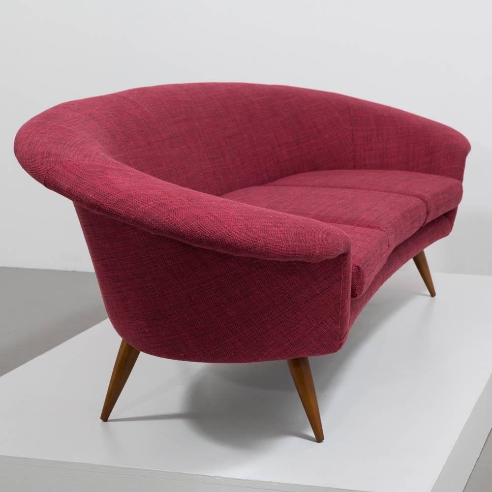 A Superb Subtlety Curved Danish Three Seater Sofa 1960s Reupholstered by Talisman in a Rich Textured Bordeaux Fabric 

This simple and elegantly designed sofa is beautiful from all angles with its dramatic overhanging arm that swoops and wraps all