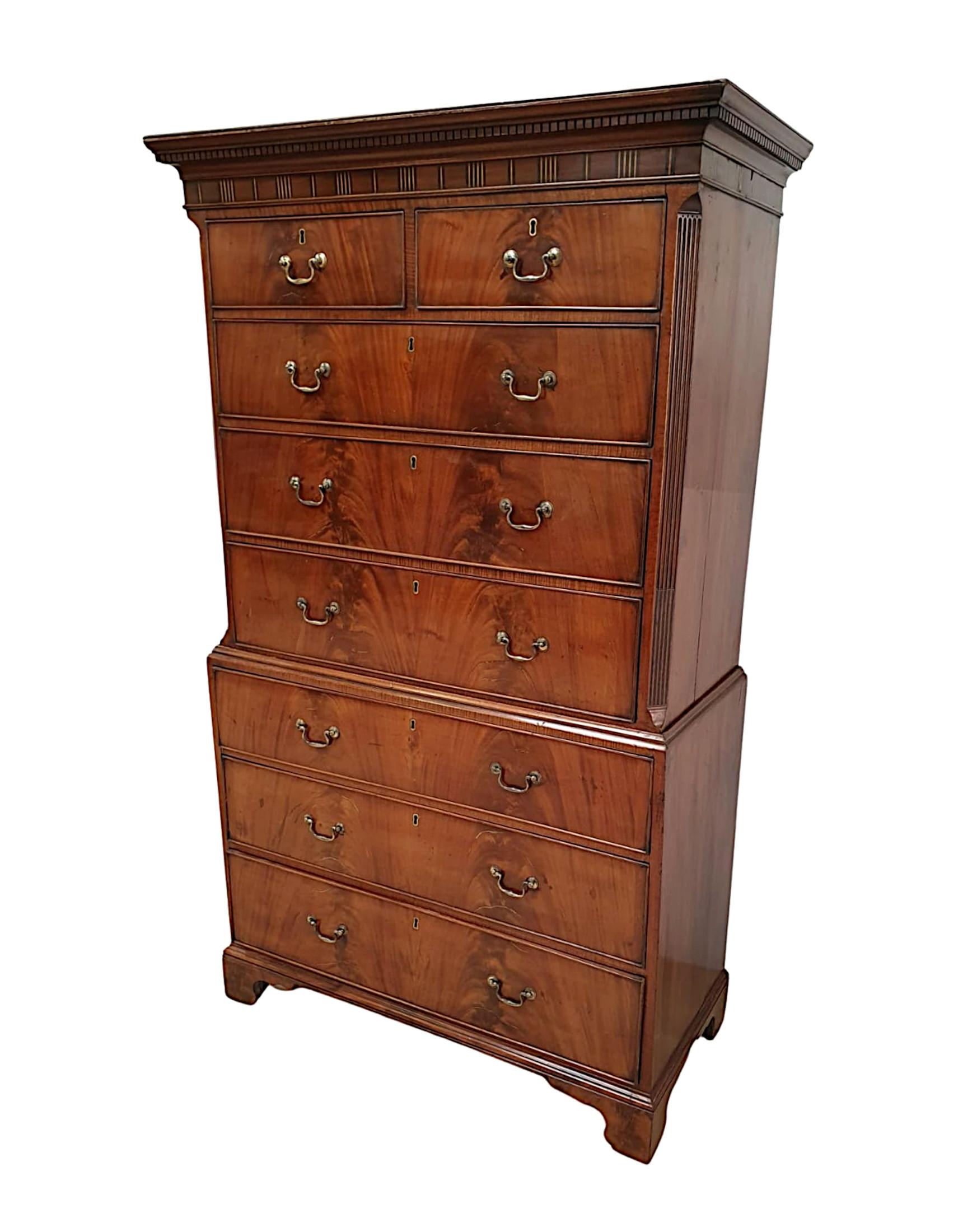 A superb early 19th century George III flame mahogany chest on chest, the upper section with a stepped moulded Cavetto cornice and finely hand carved detail raised over two short and three long graduated drawers, all cockbeaded with decorative brass