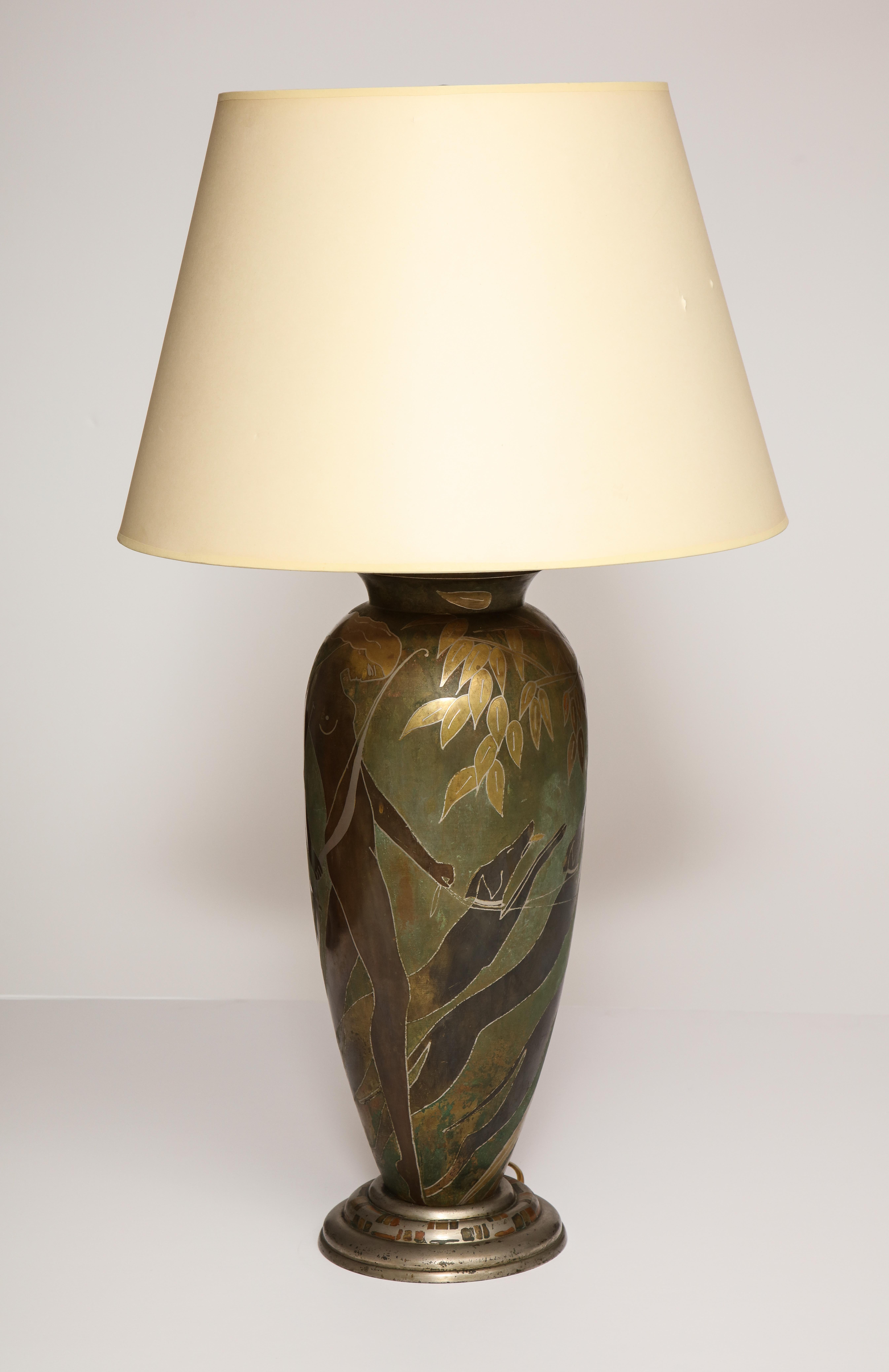 French Art Deco Dinanderie table lamp. The assorted metals and patina depicting Diana. Having original hardware, rewired recently. Signed M. Poincet.
 