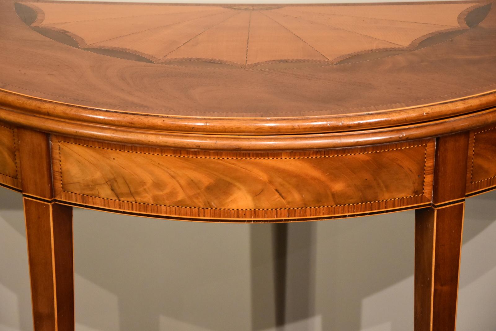 A superb George III mahogany inlaid demilune card table

Measures: Height 29.5