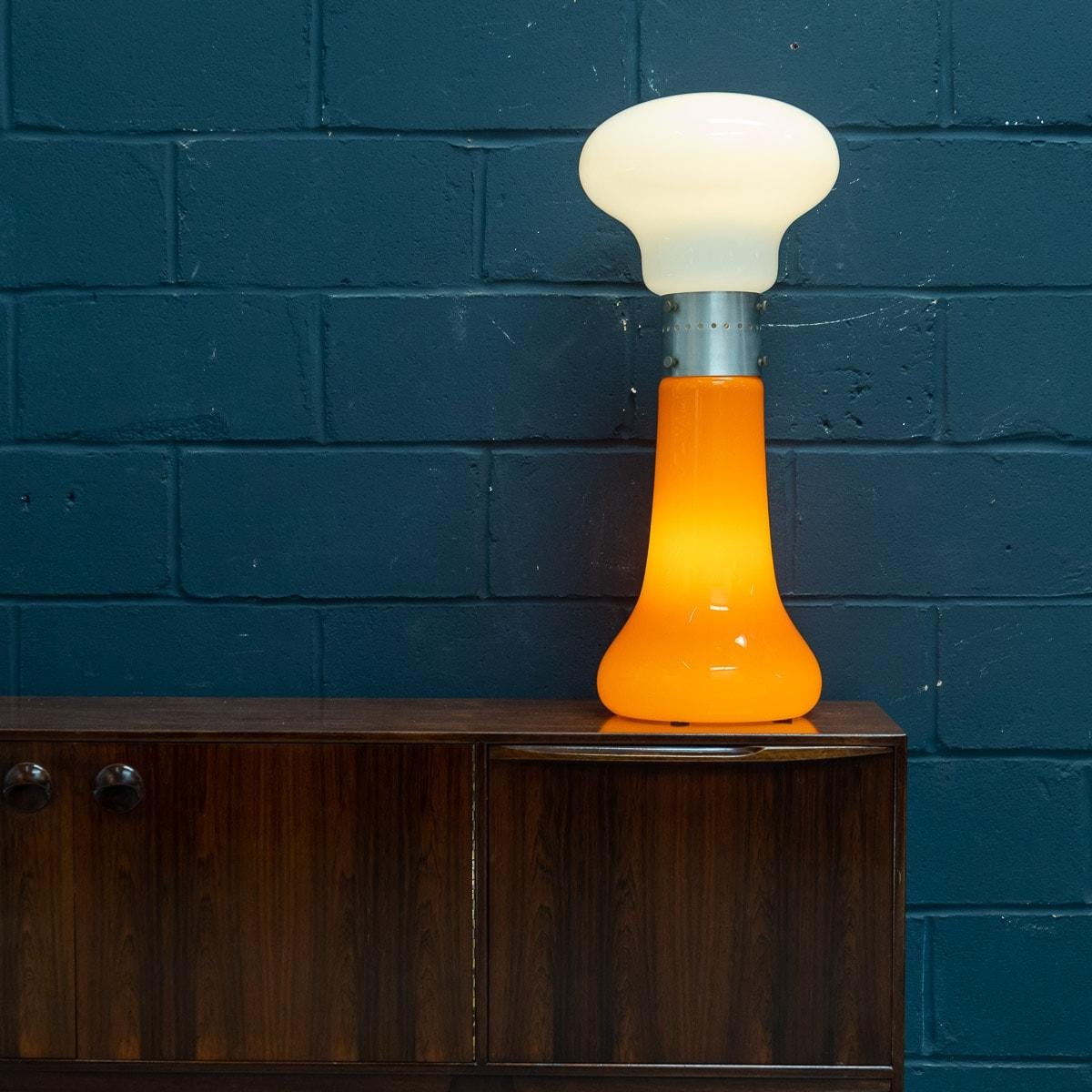 A superb vintage Italian table lamp made by Carlo Nason for Mazzega. Produced in Murano, Venice in the 1970s, this chrome and glass lamp exemplifies Carlo Nason’s workmanship. Using vibrant colours, Nason has used a bright orange glass for the base