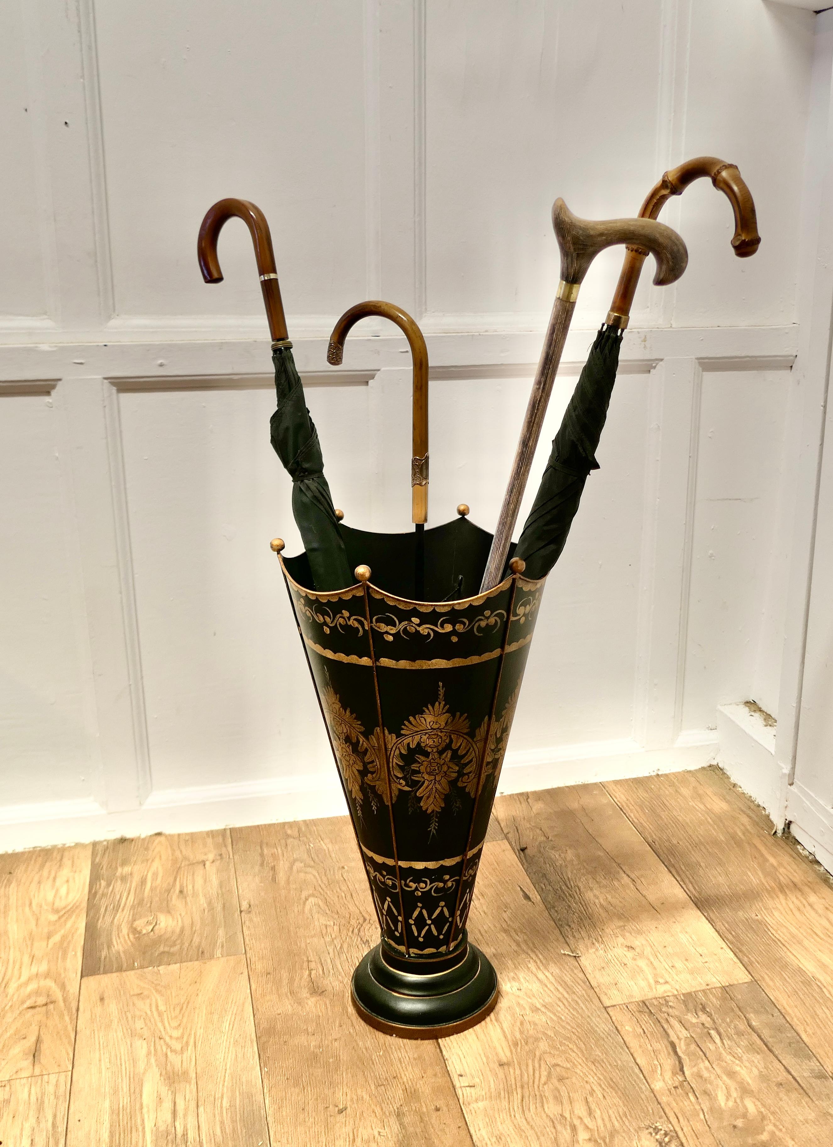 A Superb Italian Toleware Umbrella Stand, Hand Painted Gold on Black

A very unusual and attractive piece, hand painted and made in Tolewear, it is decorated with garlands of leaves
The stand is divided into 6 sections and has an elegant cane handle