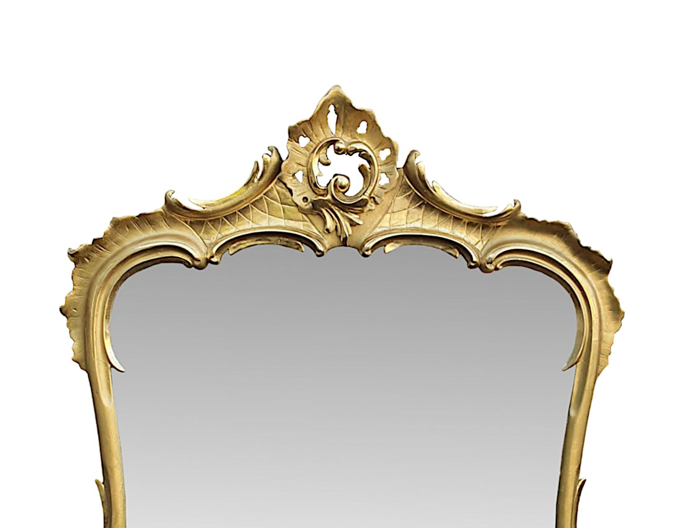 A superb 19th century giltwood overmantle mirror of large proportions. The original mercury glass plate with some mottling, is set within a beautifully shaped giltwood frame of rectangular form. The finely hand carved, moulded frame is richly