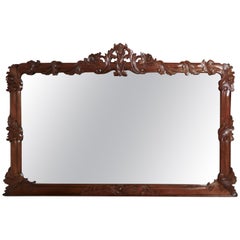 Superbe grand miroir surmonté en acajou sculpté