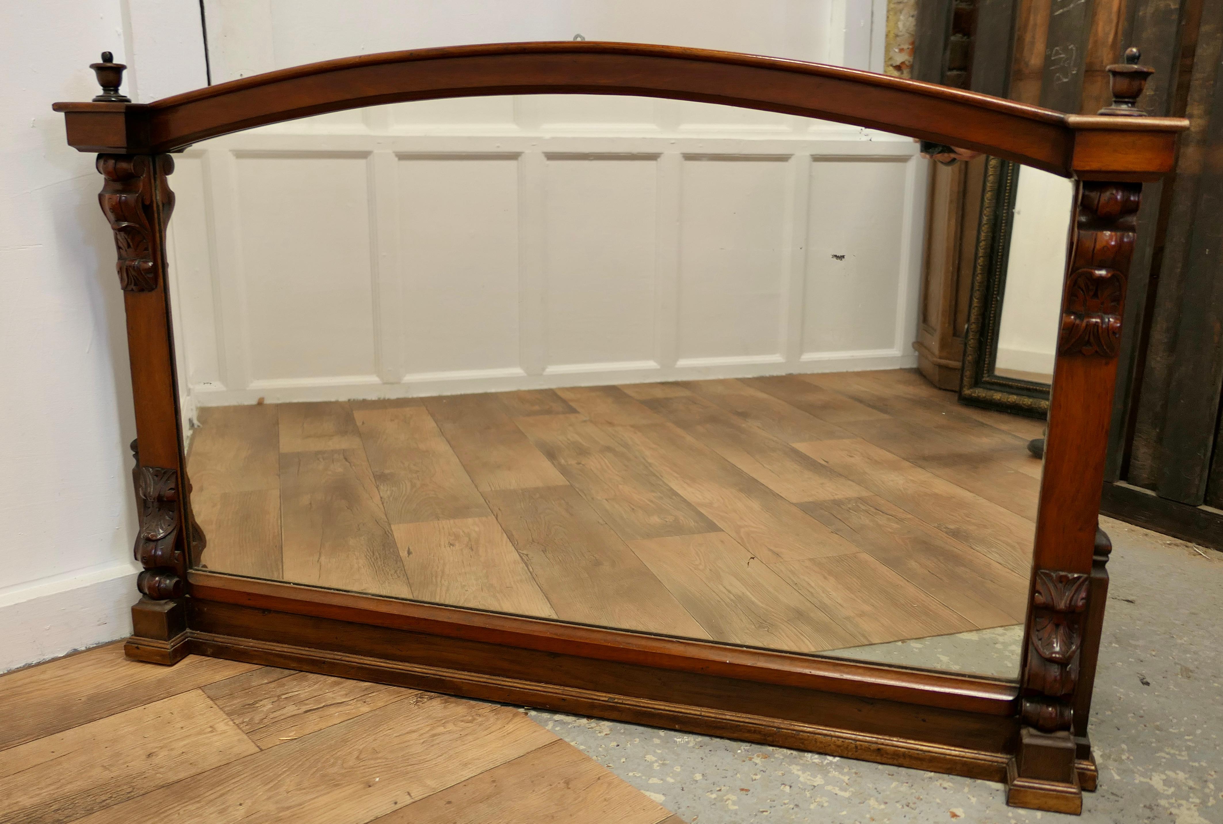 A Superb Large Carved Walnut Overmantel Mirror 

This is a Striking piece it has a rectangular shape with a curved top, on each side there is carving both top and bottom with leaves 
The mirror is in lovely red Walnut and would set off the