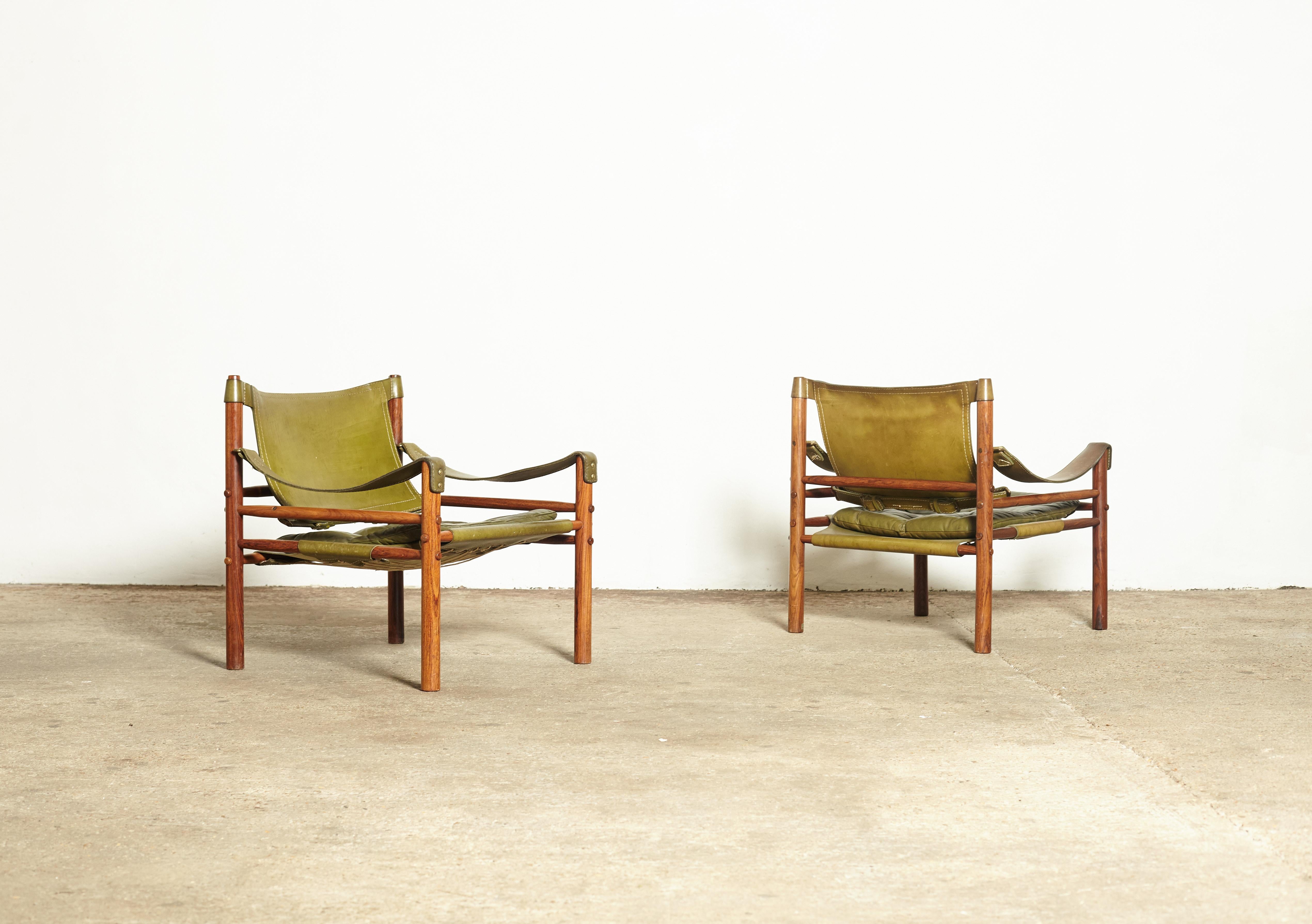 A super pair of authentic vintage Arne Norell safari sirocco chairs in rosewood and patinated green leather. Made by Norell Mobler in Sweden. Priced and sold as a pair together. 

Good original condition. Wear consistent with age and use. Some signs